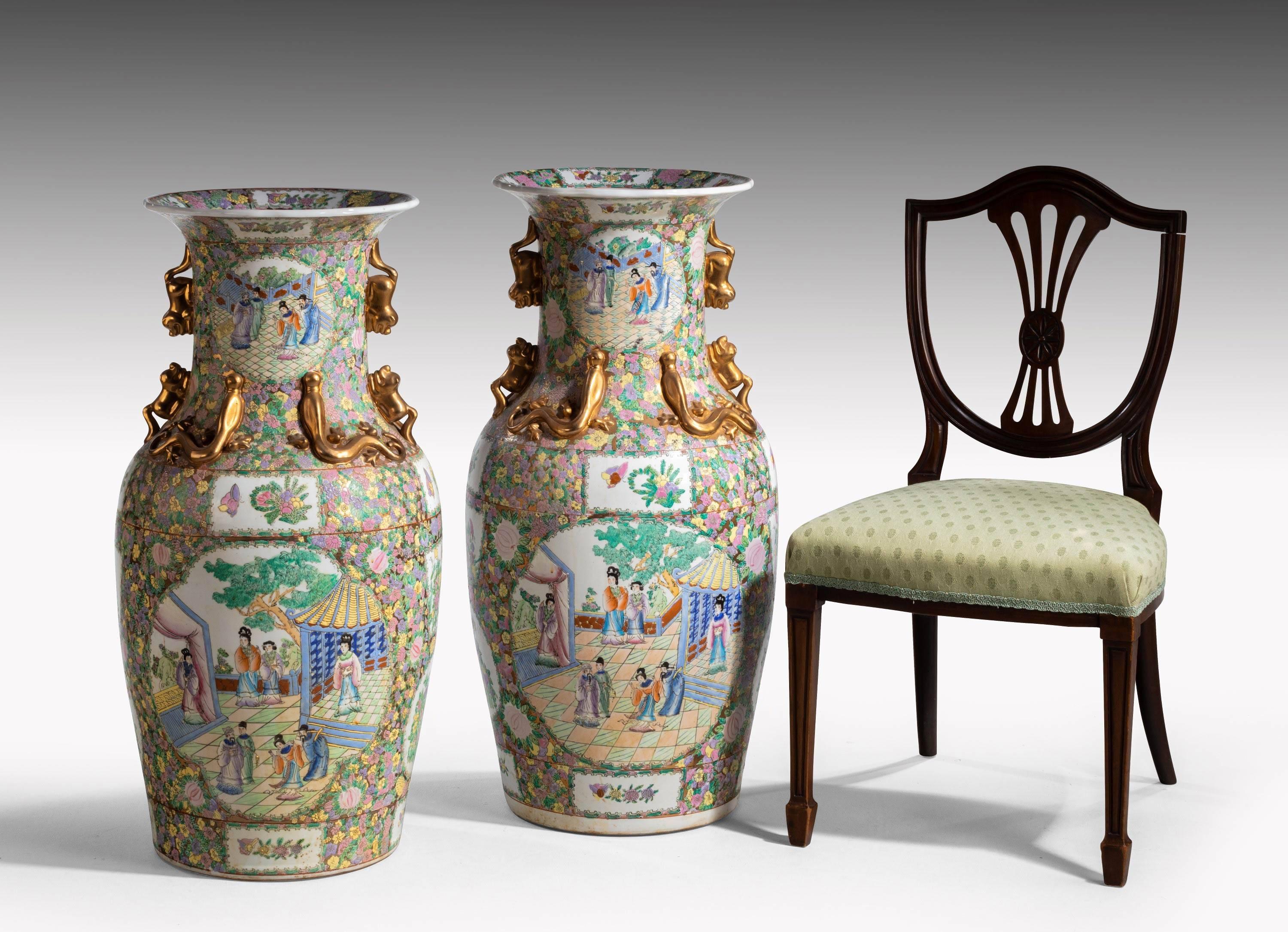 A massive pair of porcelain Cantonese vases. Hugely enriched with court scenes, foliage, flowers and exotic lizards. Beautifully painted and with original gilding, all of which is in exceptional condition.
 