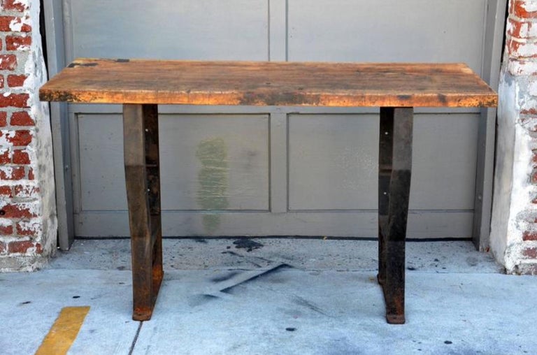 Massive patinated industrial console. The base attaches to the wall and/or the floor.