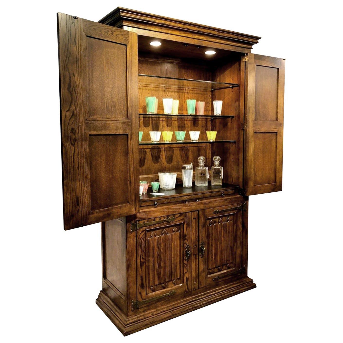 This stately bar cabinet by Henredon is the next best thing to owning your own speakeasy. This massive monolith of masculinity exudes luxury with its richly aged pecan wood. The decades old vintage liquor cabinet features ornate wood doors and trim