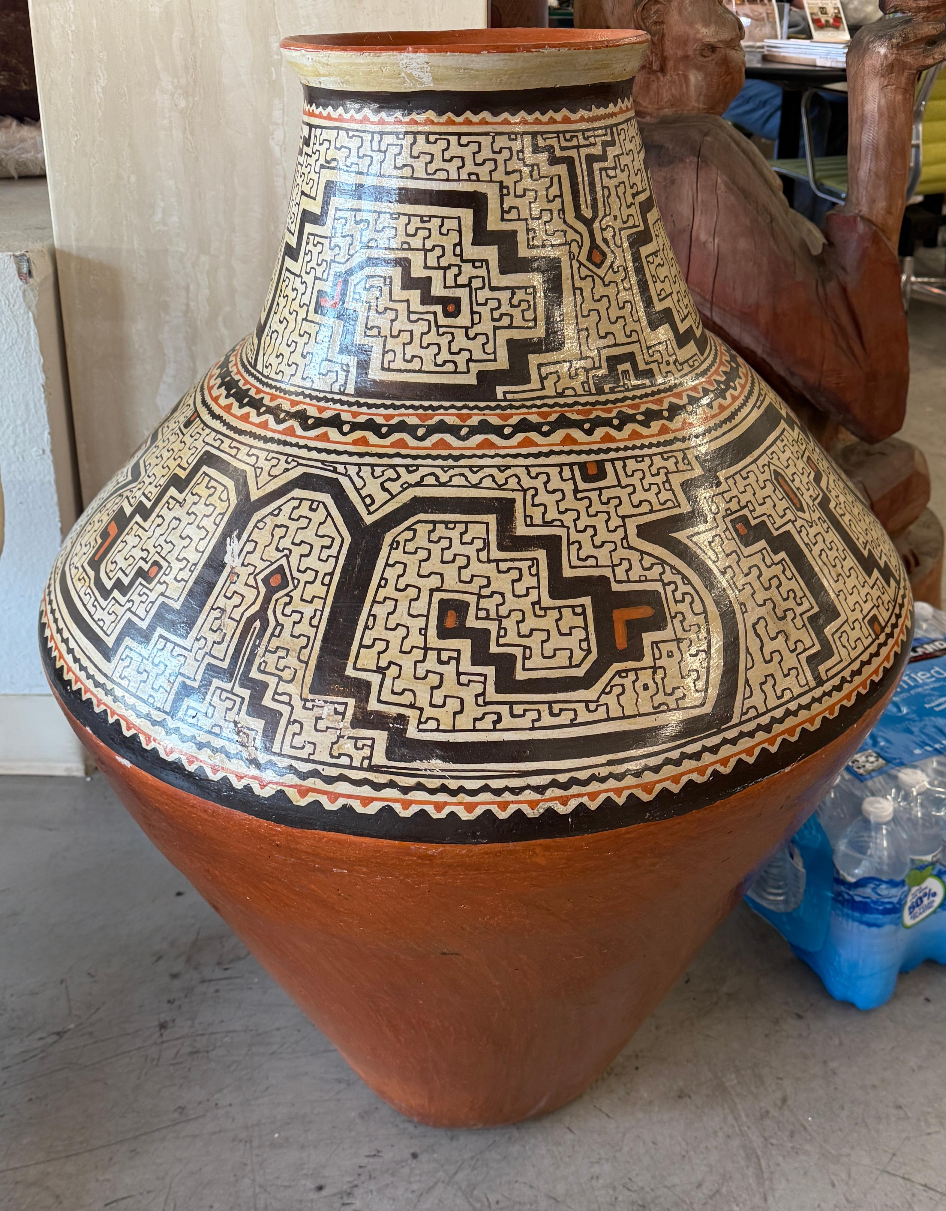 A massive large and heavy Peruvian Shipibo Cnibo or Konibo pottery vessel. It is over 34 inches tall and 26 1/2 inches in diameter at its widest point. The paint is in generally good condition although there are a few spots missing, which we have