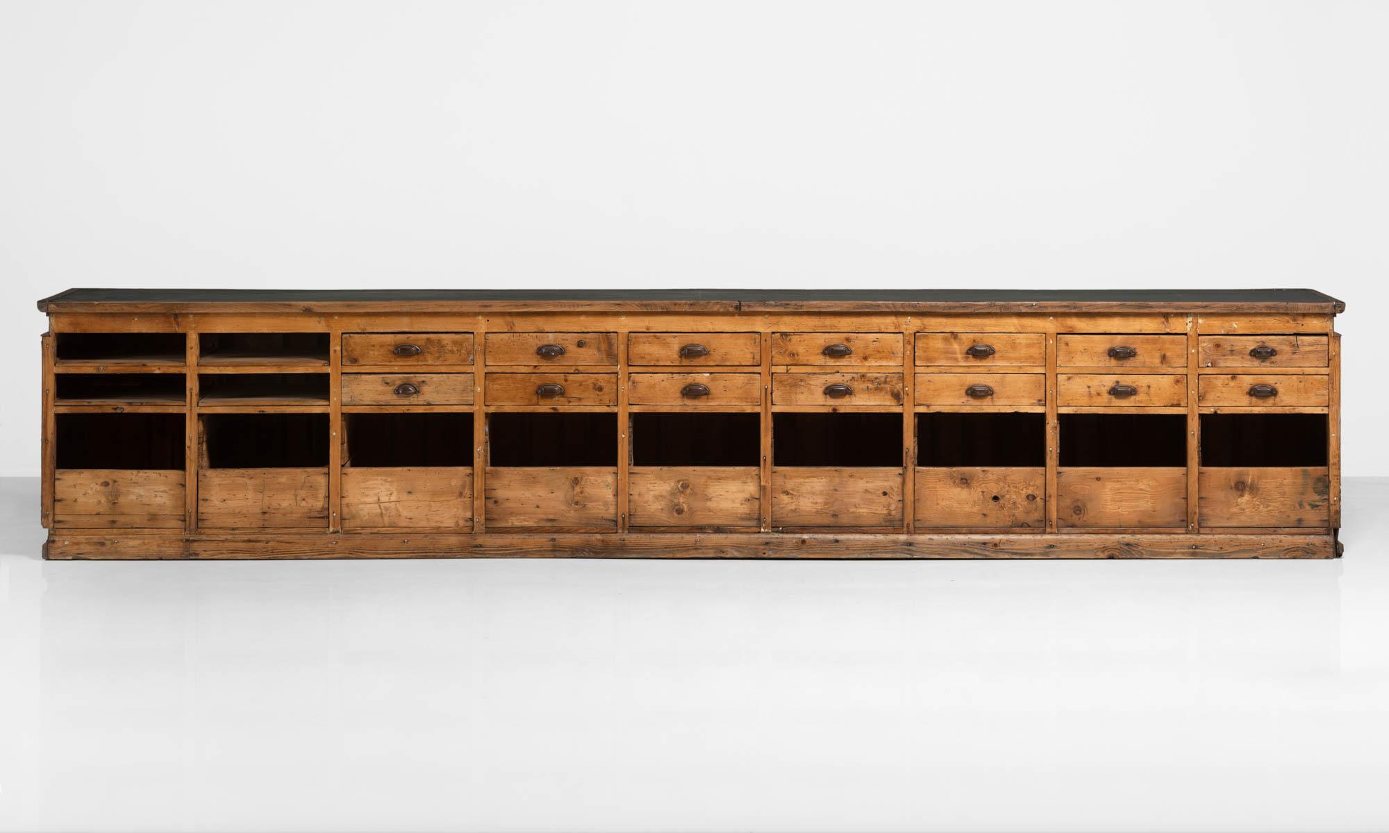 Massive pine chest of drawers, Italy, circa 1940.

Impressive storage unit with multiple drawers, bins and black mica top.