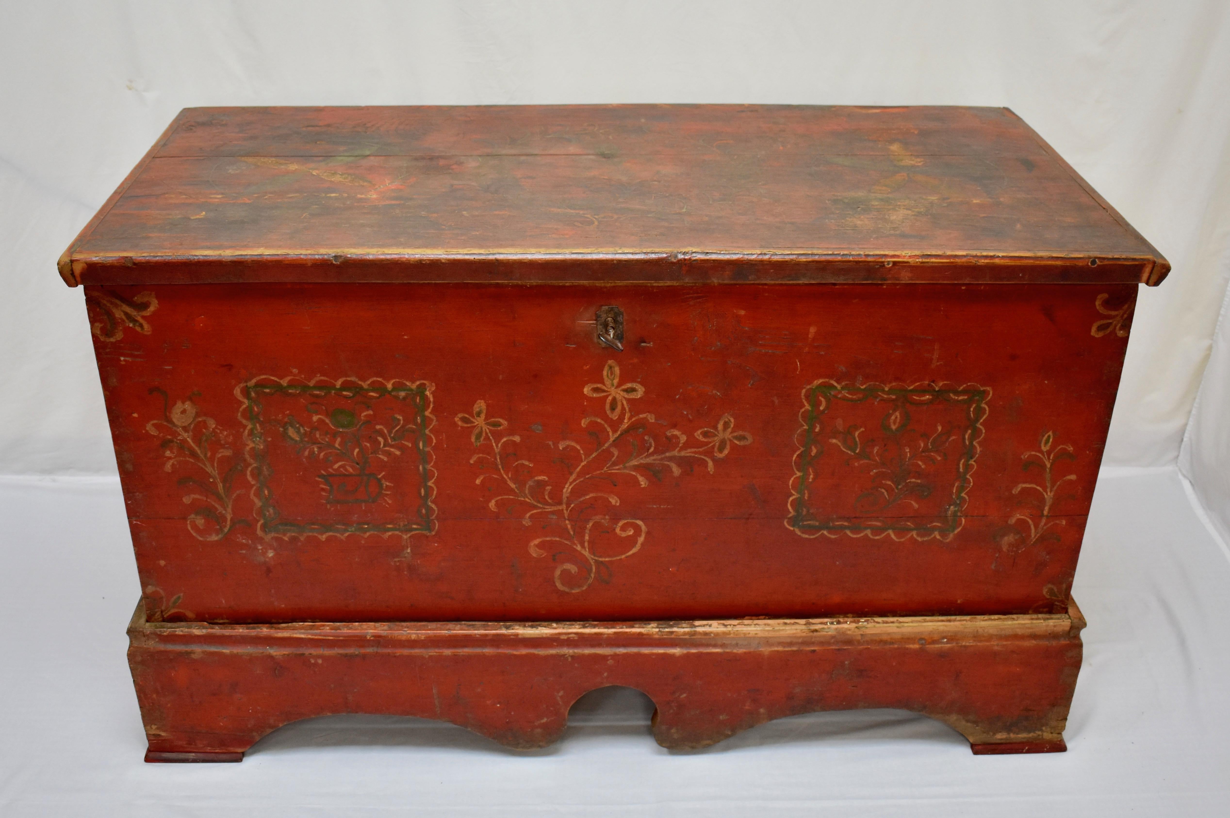 This is a very large and handsome mid-19th century trunk or blanket chest of considerable presence, probably created as a gift for a bride, to be used as a repository for all the important linens of the new household. A hand-cut dovetailed box sits