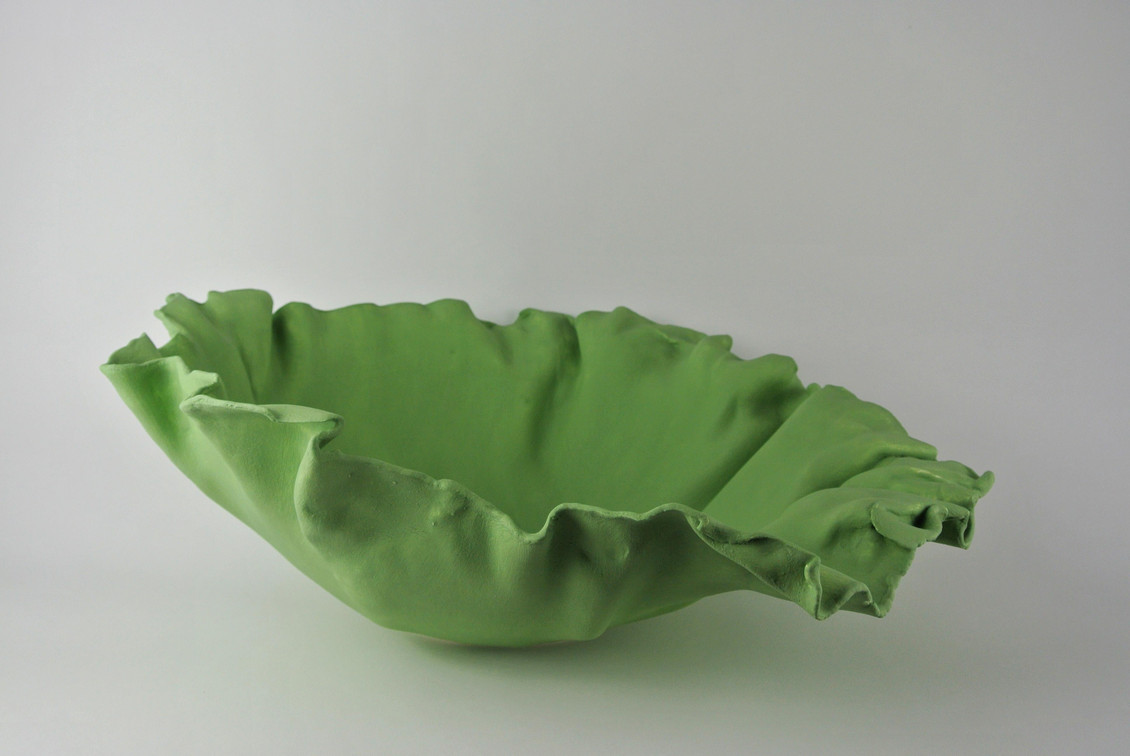 Massive asymmetric porcelain bowl with lichen green engobe. Pleated in an asymmetric petal-like shape. Functional but not suitable for holding liquids.