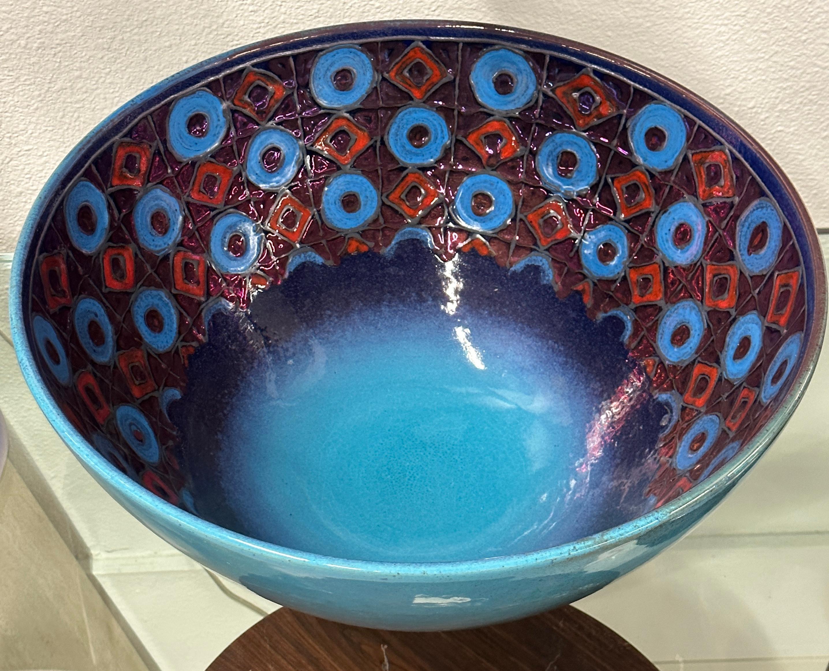 A stunning massive pottery bowl by Bottega Vignoli of Faenza Italy. The firm was founded in 1976 by sisters Saura and Ivana. This vibrant piece is signed and dated on the bottom 2014. Marked special collection 5/5. In good condition.
