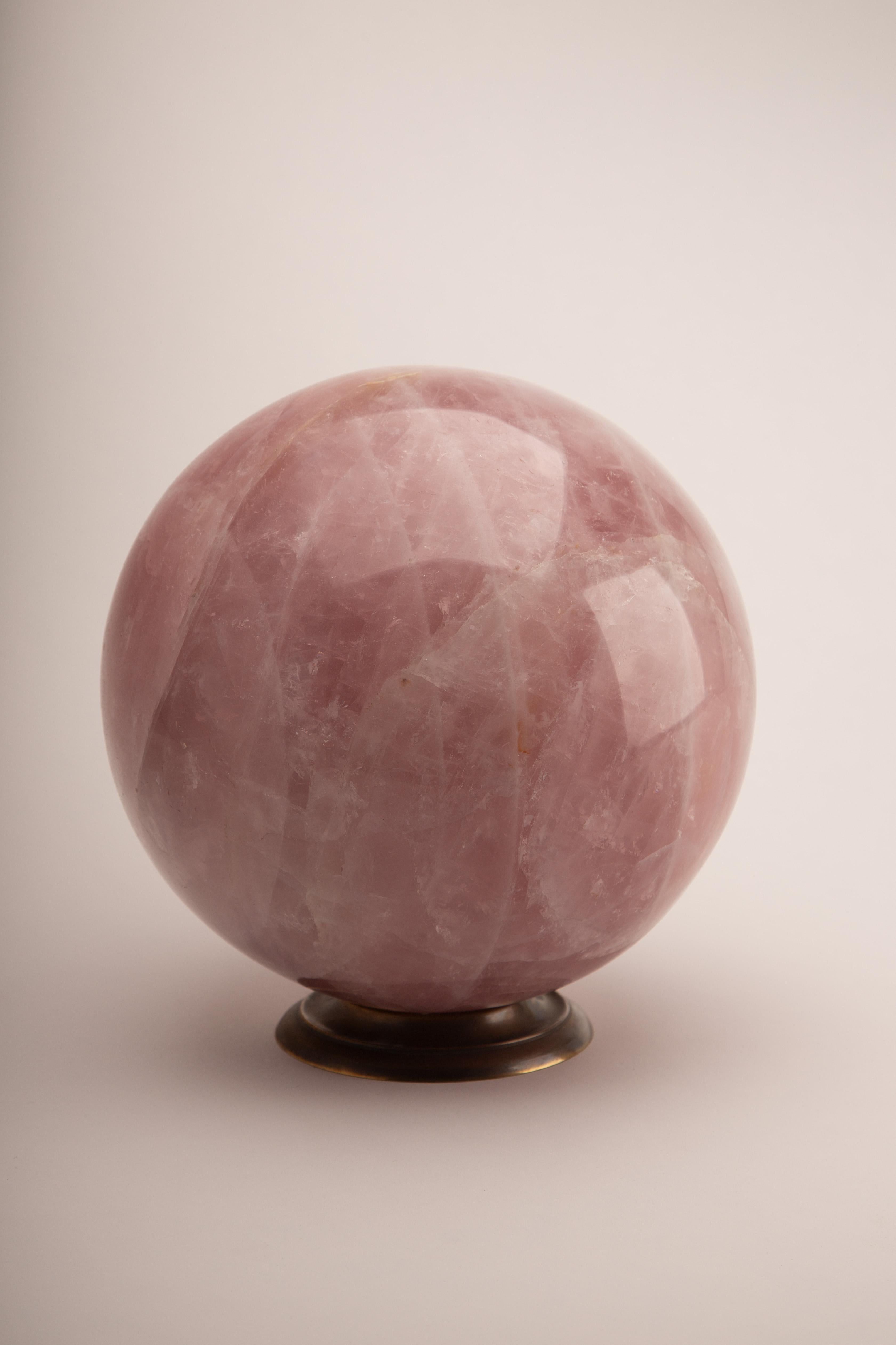 Extra Large Rose Quartz Sphere, measuring approximately 8 inches in diameter, expertly polished to showcase its soft pink hues and natural internal striations. Revered as the “stone of unconditional love,” rose quartz is believed to promote