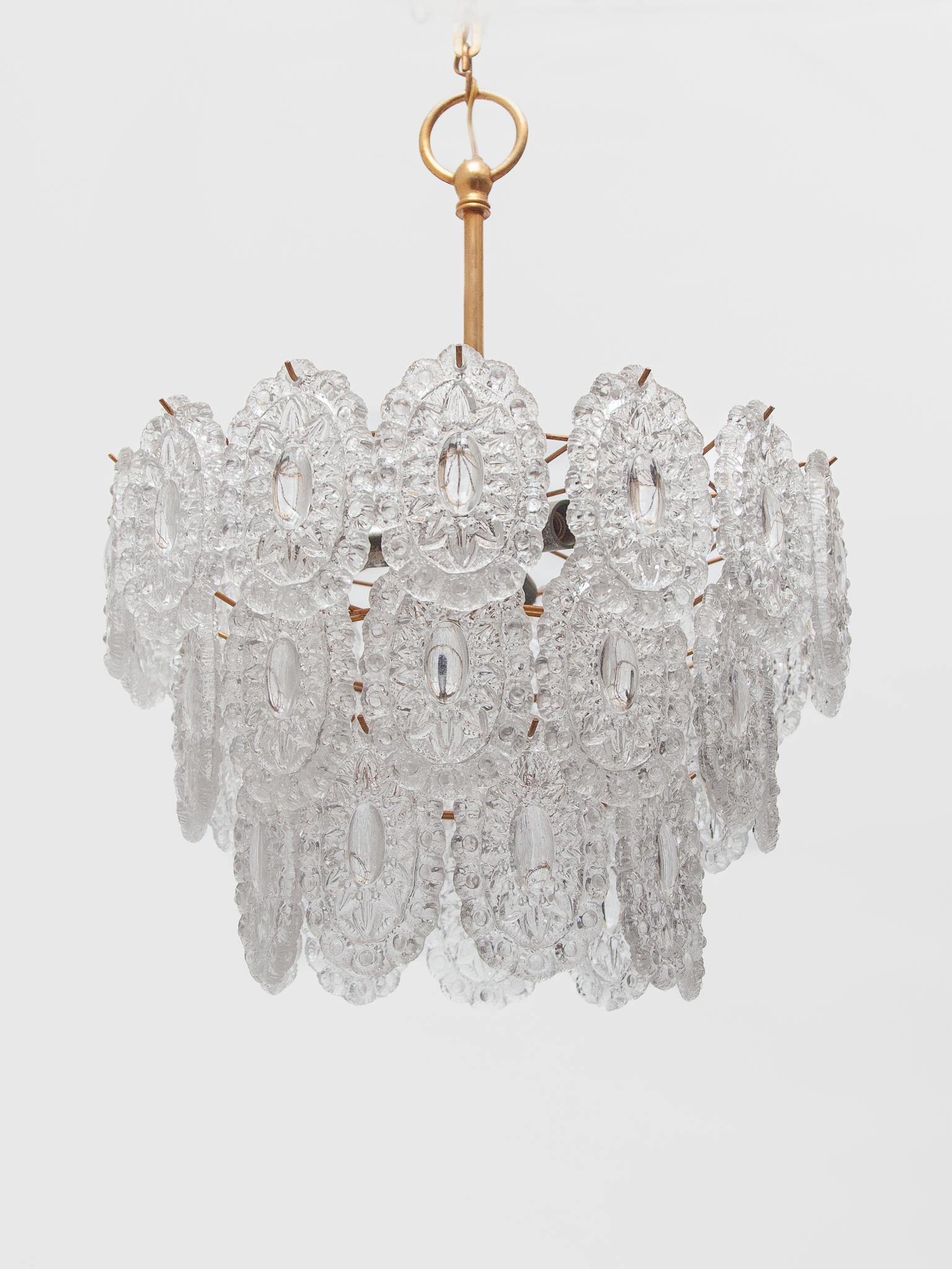 This Massive Rosette crystal glass chandelier with a brass frame made in the style of the famous Murano chandeliers with hand blown round discs in many colours. These discs are made of pressed crystal glass and are all the same. The glass was made