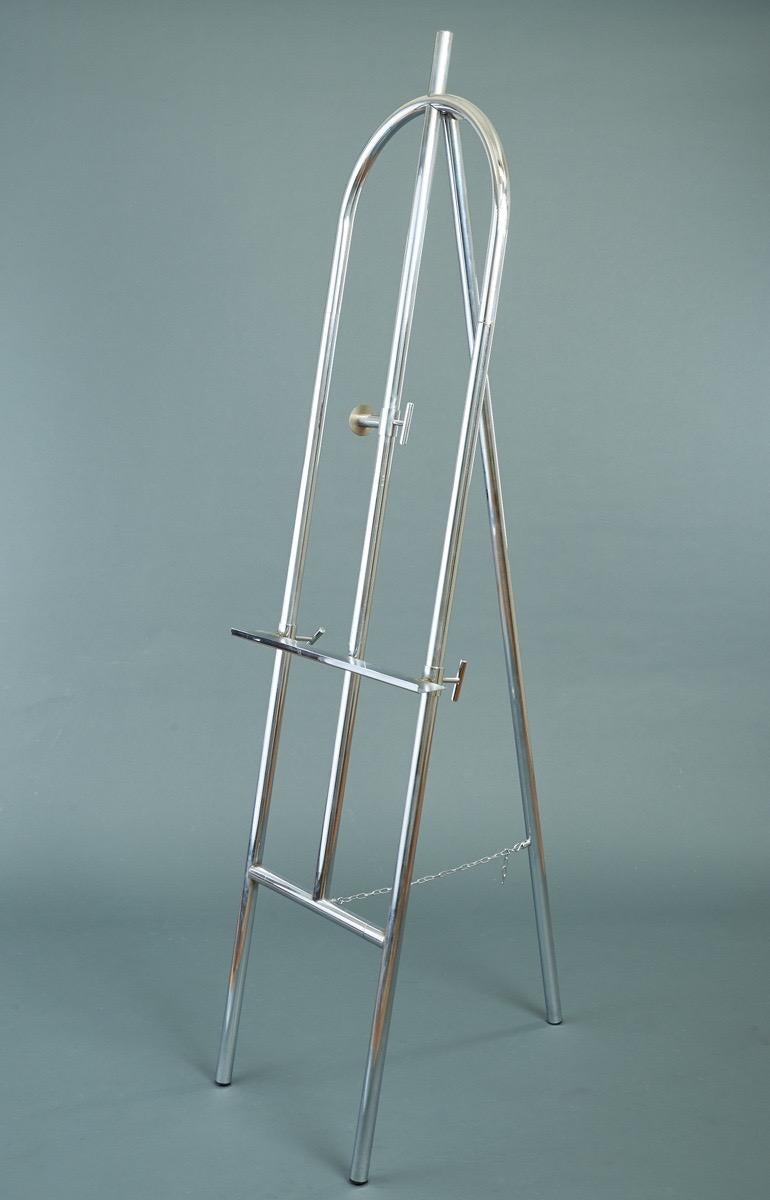 France, 1970s

A very large, sculptural, adjustable tubular chromed steel easel with a fluid and streamlined design, a subtle intermarriage of angles and curves. Can hold a mirror, painting, or stand on its own.

Measures: 6 ft. 7 in H x 24 in W.