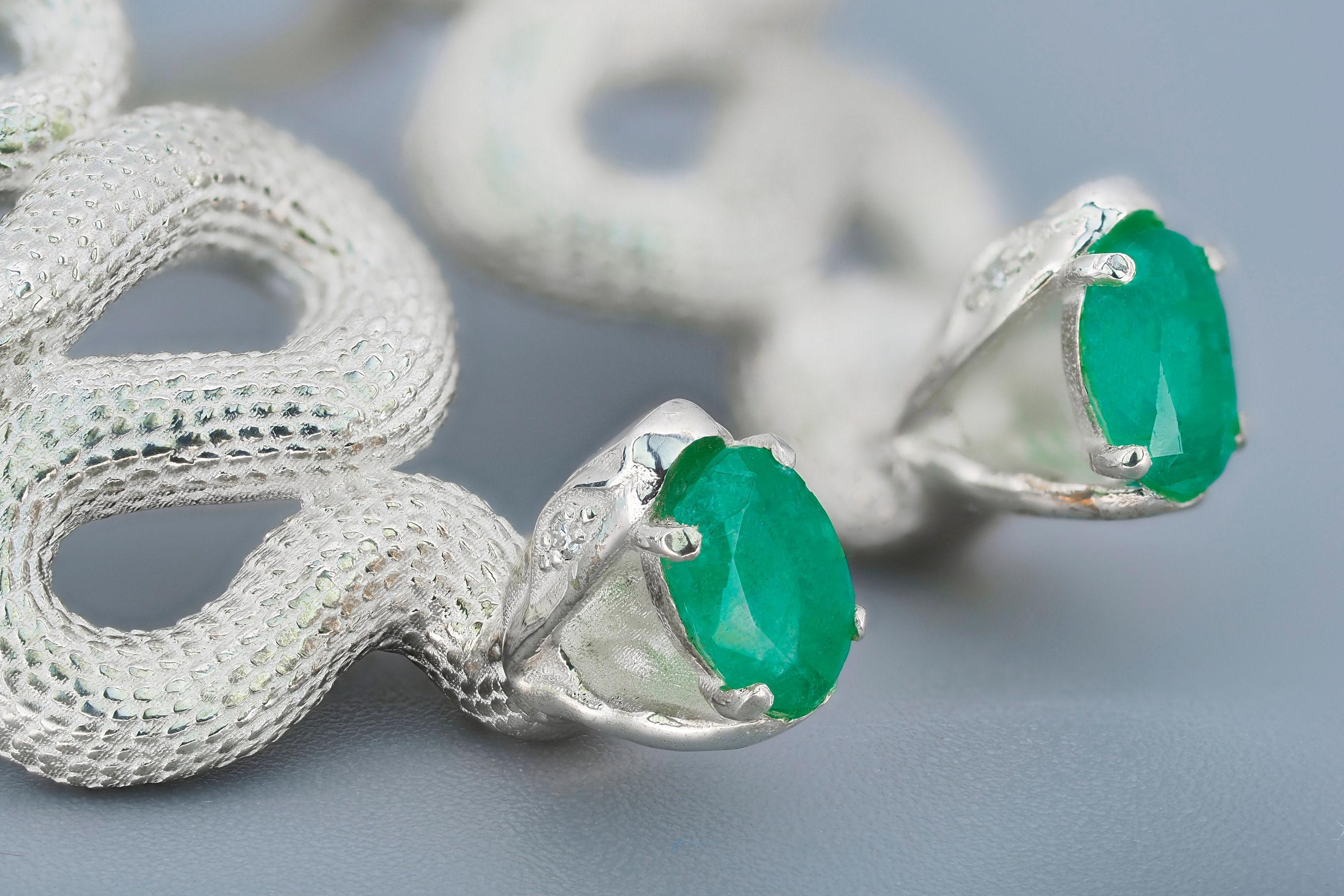 Massive snake earrings.

Metal: 925 silver
Total weight: 13.3 g.
Size 42.9x17.5 mm.

Central stones: Natural Emeralds - 2 pieces
Cut: Oval
Weight: aprx 1.5 ct. total.
Color: Green
Origin on seller opinion - Ural
Clarity: Transparent with
