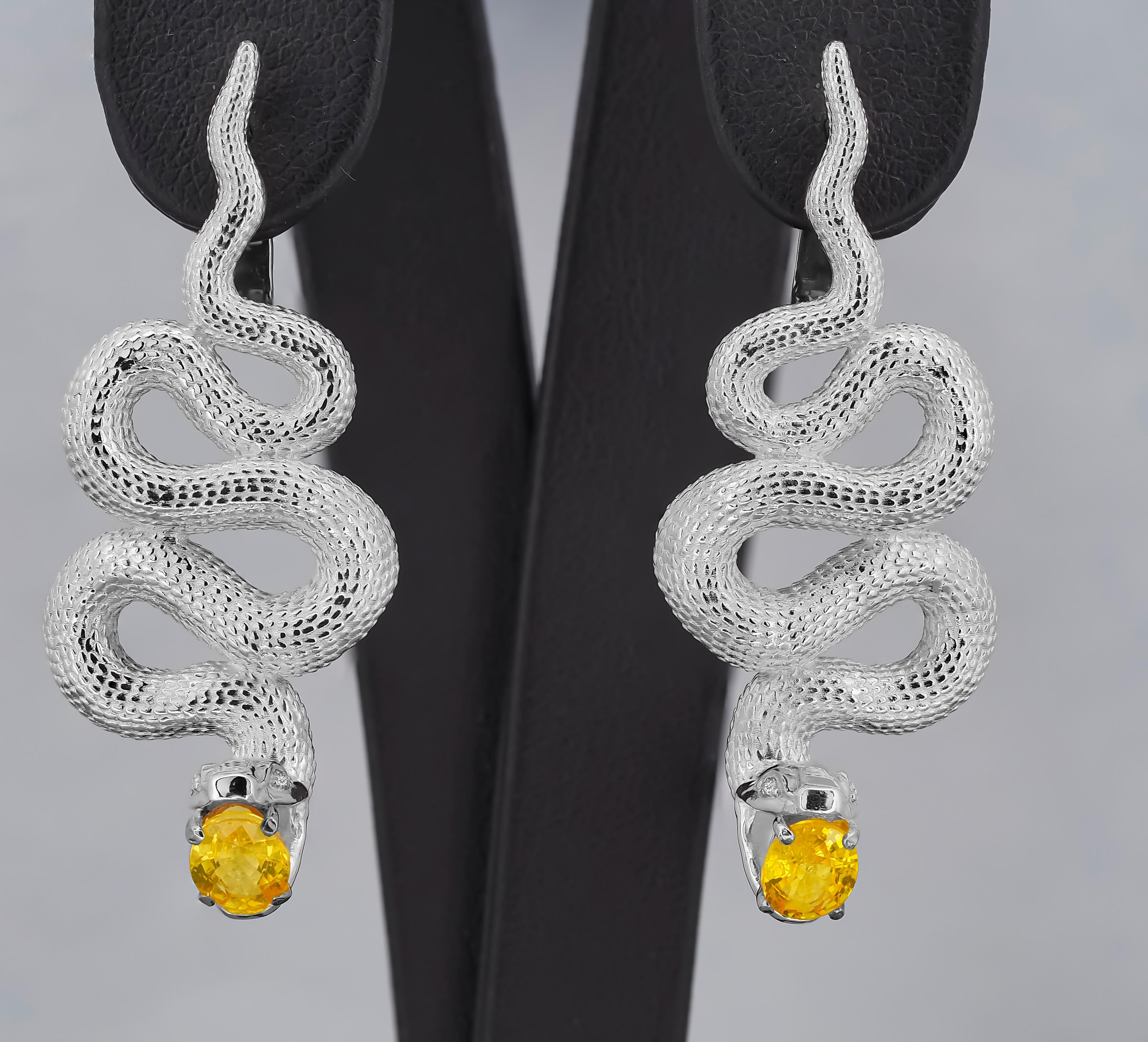 Massive Snake earrings with sapphires in opened mouth and diamonds in eyes.

Genuine sapphire earrings. Snake earrings. 
Metal: sterling silver
Earrings Total weight: 13.3 g.

Size 42.9x17.5 mm

Central stones: Natural Sapphires - 2 pieces
Cut: