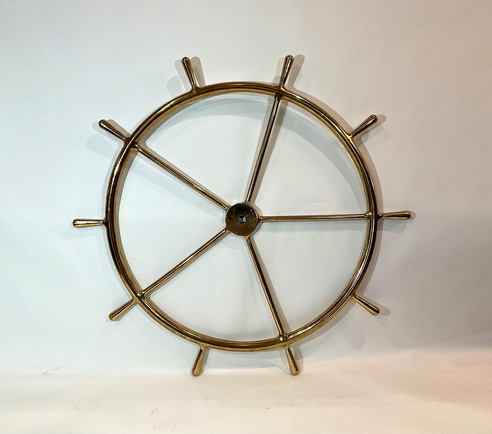 Brass ships wheel that has been meticulously polished and lacquered. Five spokes with ten handles. Stunning piece, five feet in diameter. Awesome maritime relic.

Weight: 83 LBS
Overall Dimensions: 60