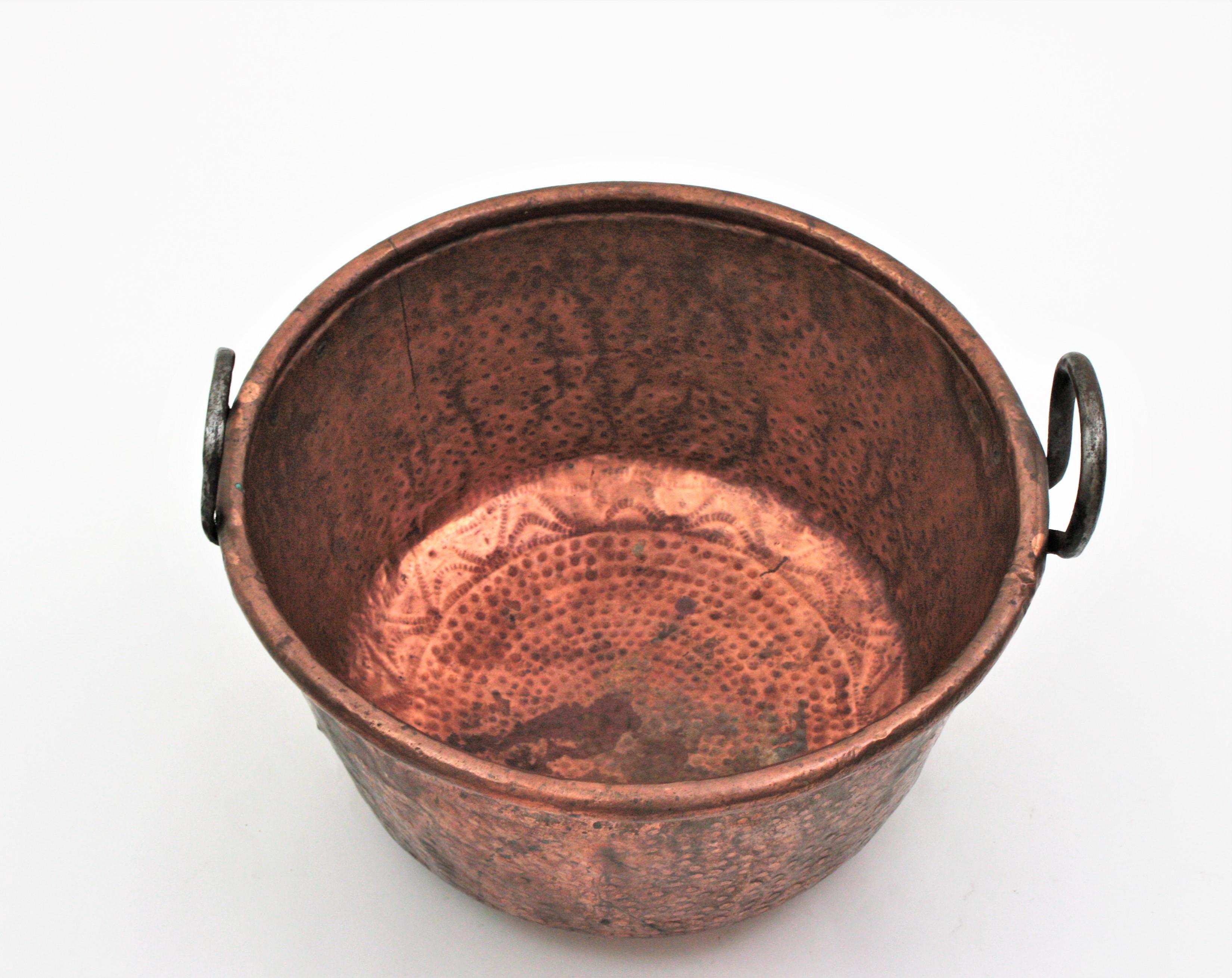 Oversized hand-hammered copper cauldron with iron handles, Spain, 1930s.
This handcrafted copper cauldron has a dramatic aged patina. The copper is heavily marked by the pass of time and it has a strong visual effect. Dramatic aged patina
The iron