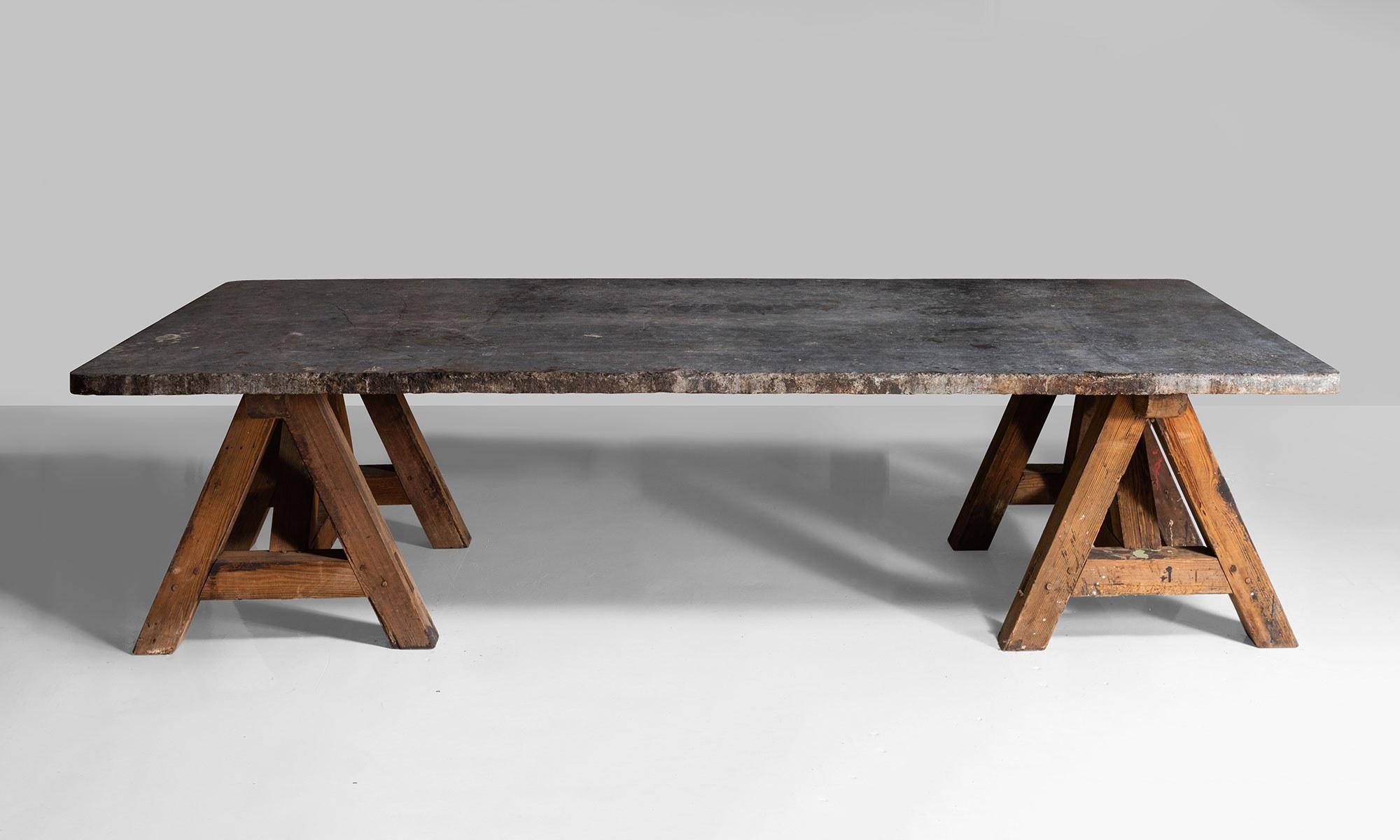 Original blue stone top on pine trestle base, originally from a leather factory.

 