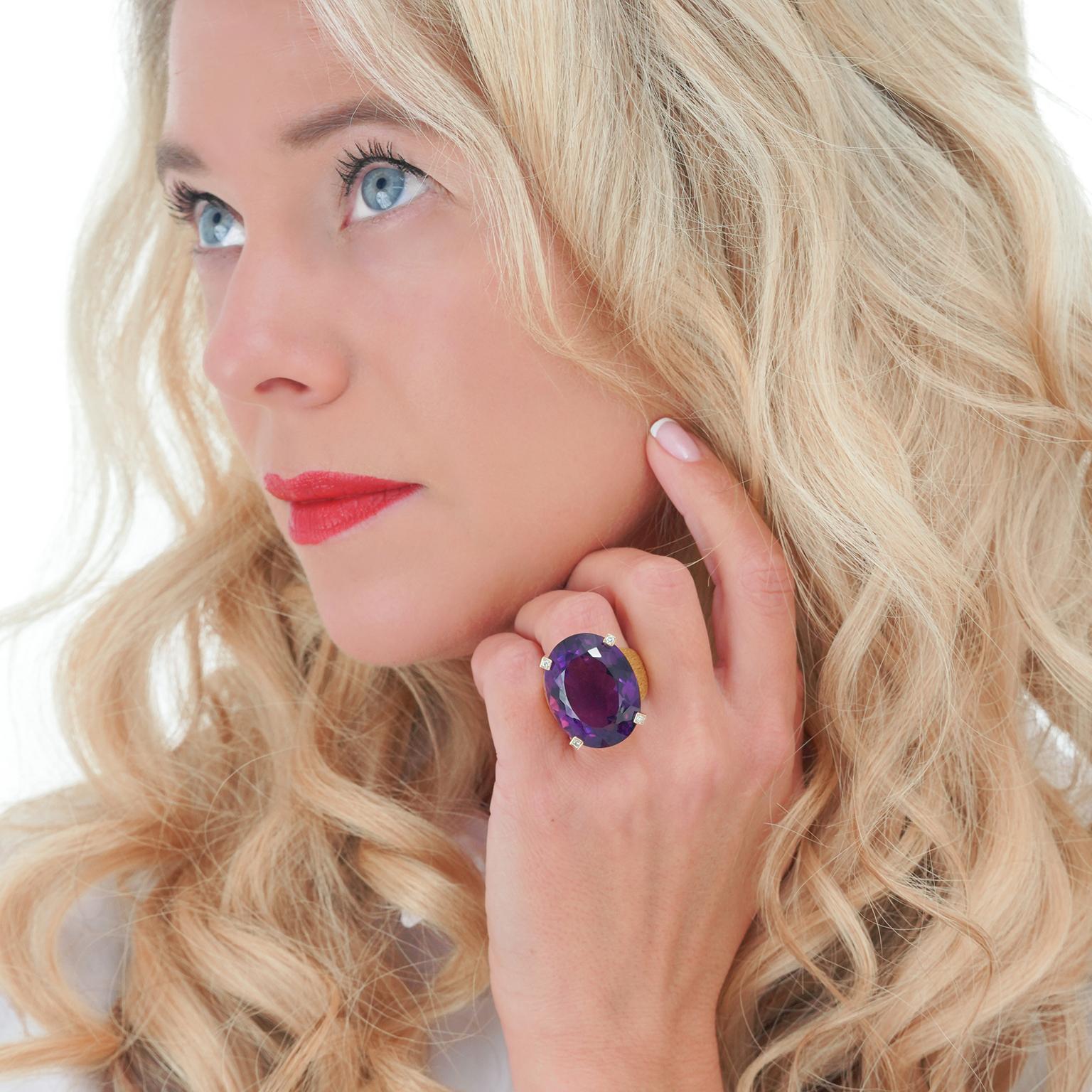 Circa 1970s, 18k, Switzerland.  This colorfully chic Modernist ring features a massive 40.0-carat amethyst. This gorgeous deeply-hued purple stone beautifully complements the minimalist contemporary design. The body of the ring is hand-textured and