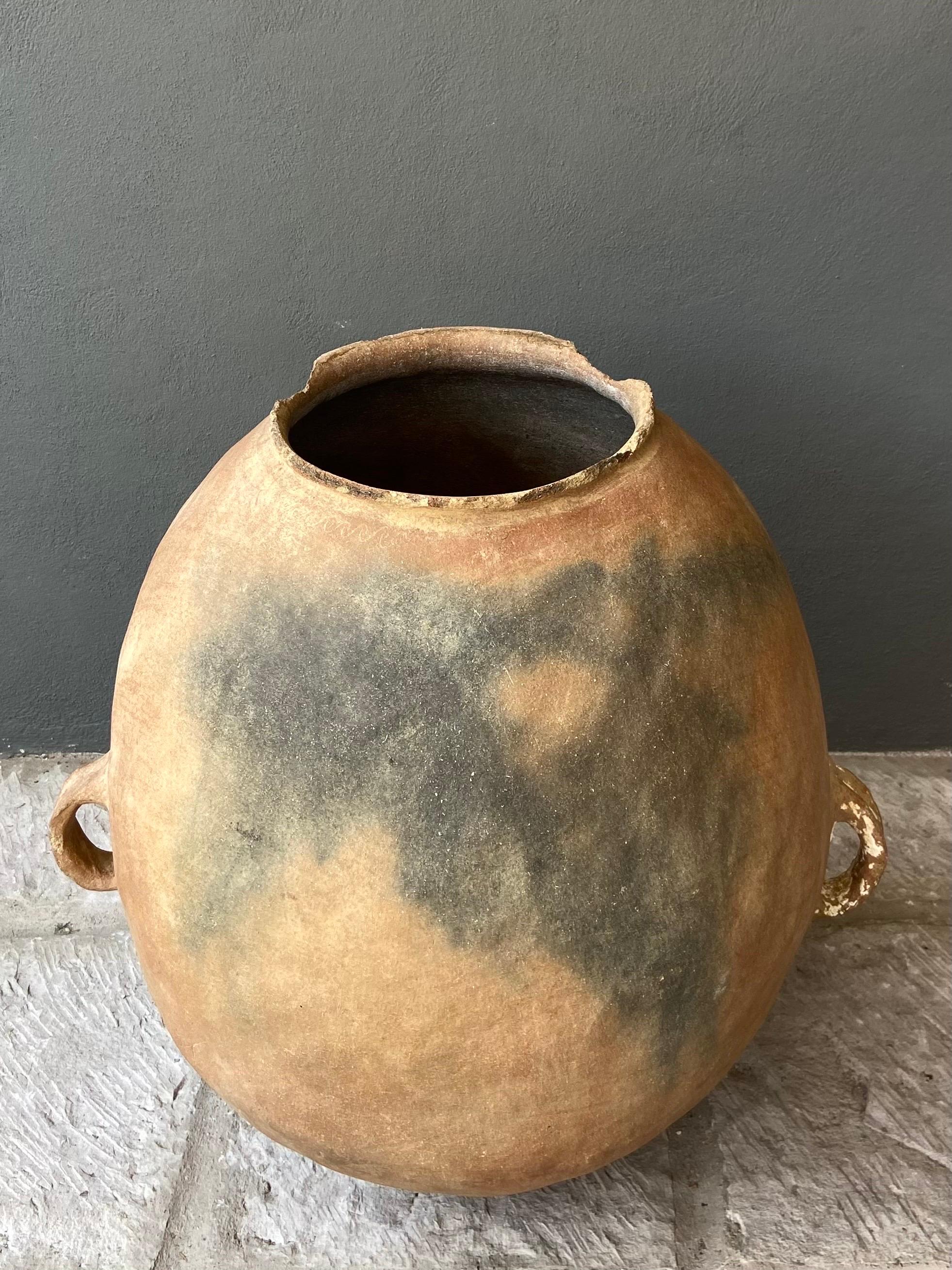 Presenting a massive water jar from the Sierra Norte region of Puebla, Mexico, circa 1920´s. Hand coiled within the Nahuatl speaking communities, these pots are scarce. Pottery such as these was discontinued in the late 1970´s with the advent of