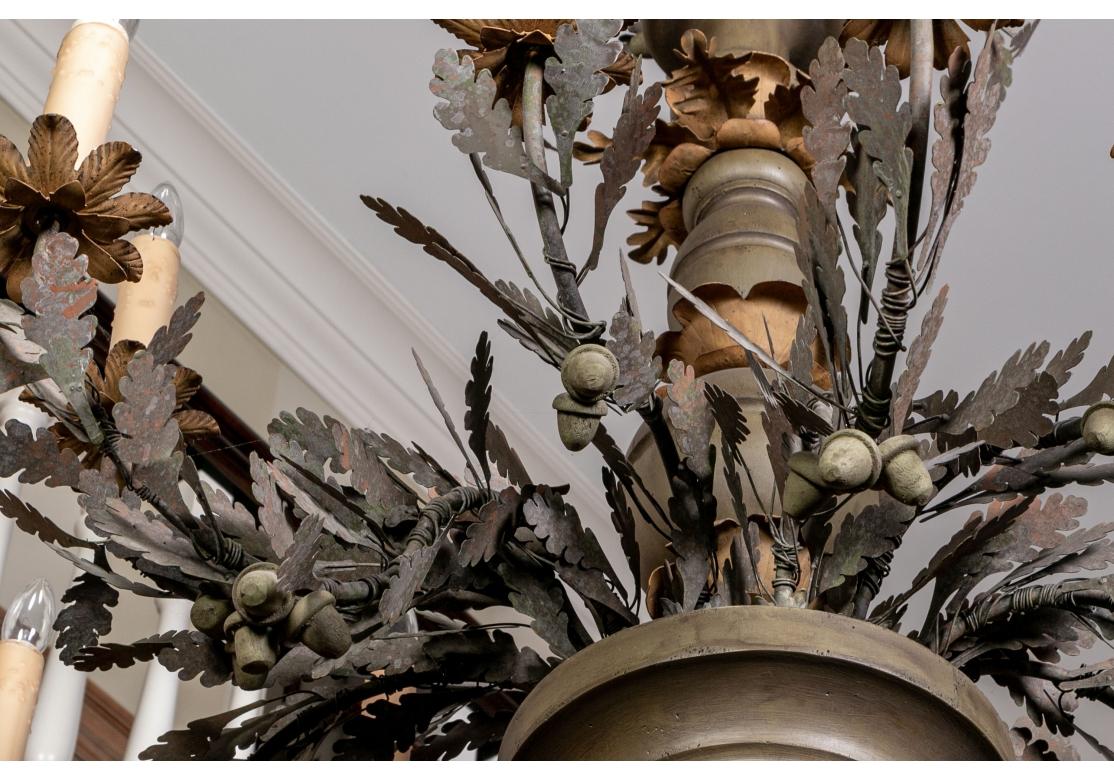 Patinated Massive Tole Leaf Decorated Ten Light Tiered Chandelier For Sale