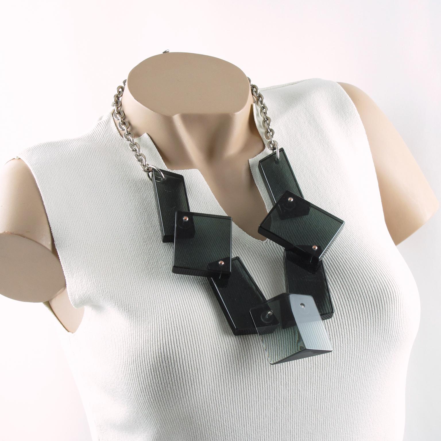 This stunning modernist bib features a modern handmade geometric choker necklace. Each extra-thick block of Lucite or Plexiglass is hinged, allowing the elements to move with the wearer's movements. The piece boasts a lovely transparent smoke
