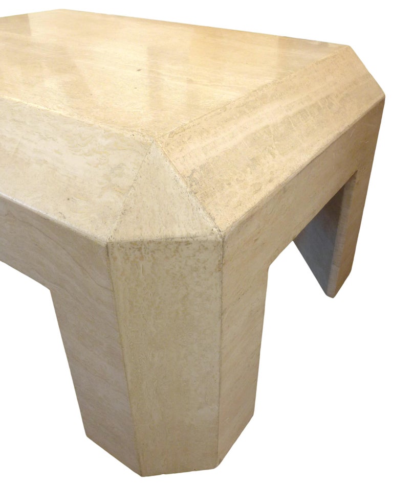 A modern and Minimalist travertine coffee table with wonderful form and proportions. Beautifully-constructed and utilitarian, with a faceted accent, adding to its impressive decorative appeal. A simple and wonderfully versatile table concept with