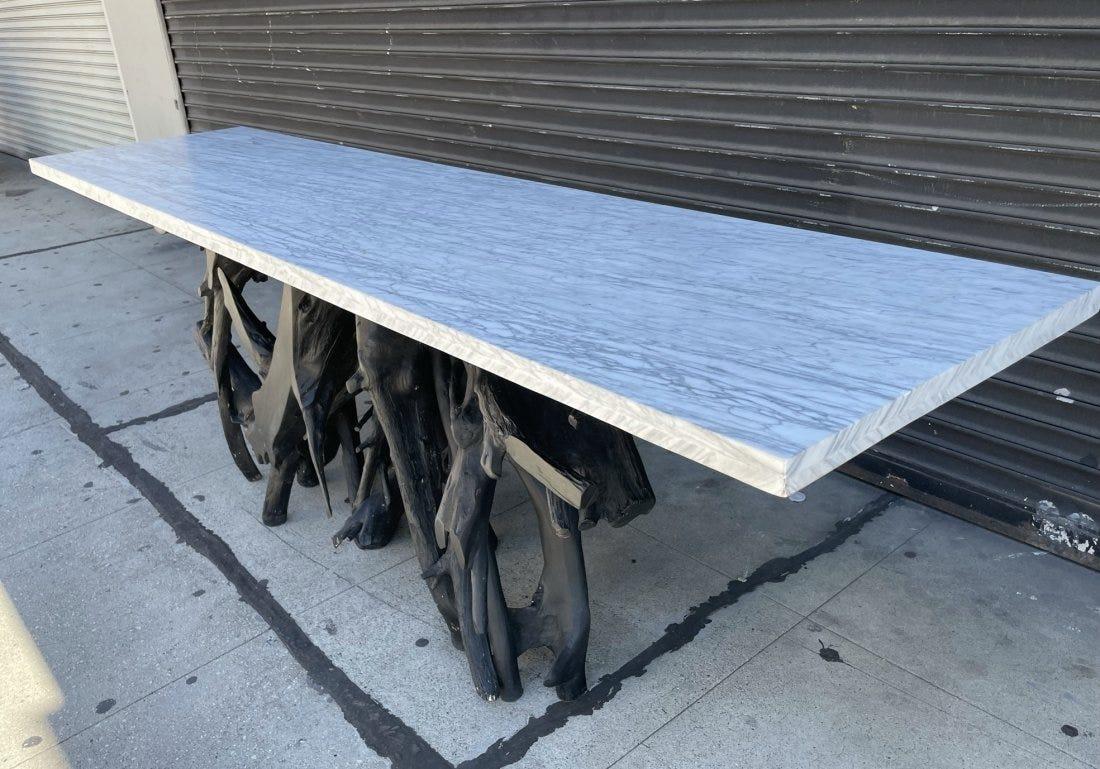 Massive tree root console table with a beautiful marble top.

The natural tree root base is painted black and the marble appears to be similar to carrara marble.

The table is heavy, the top comes off the base for easy transport.

No apparent