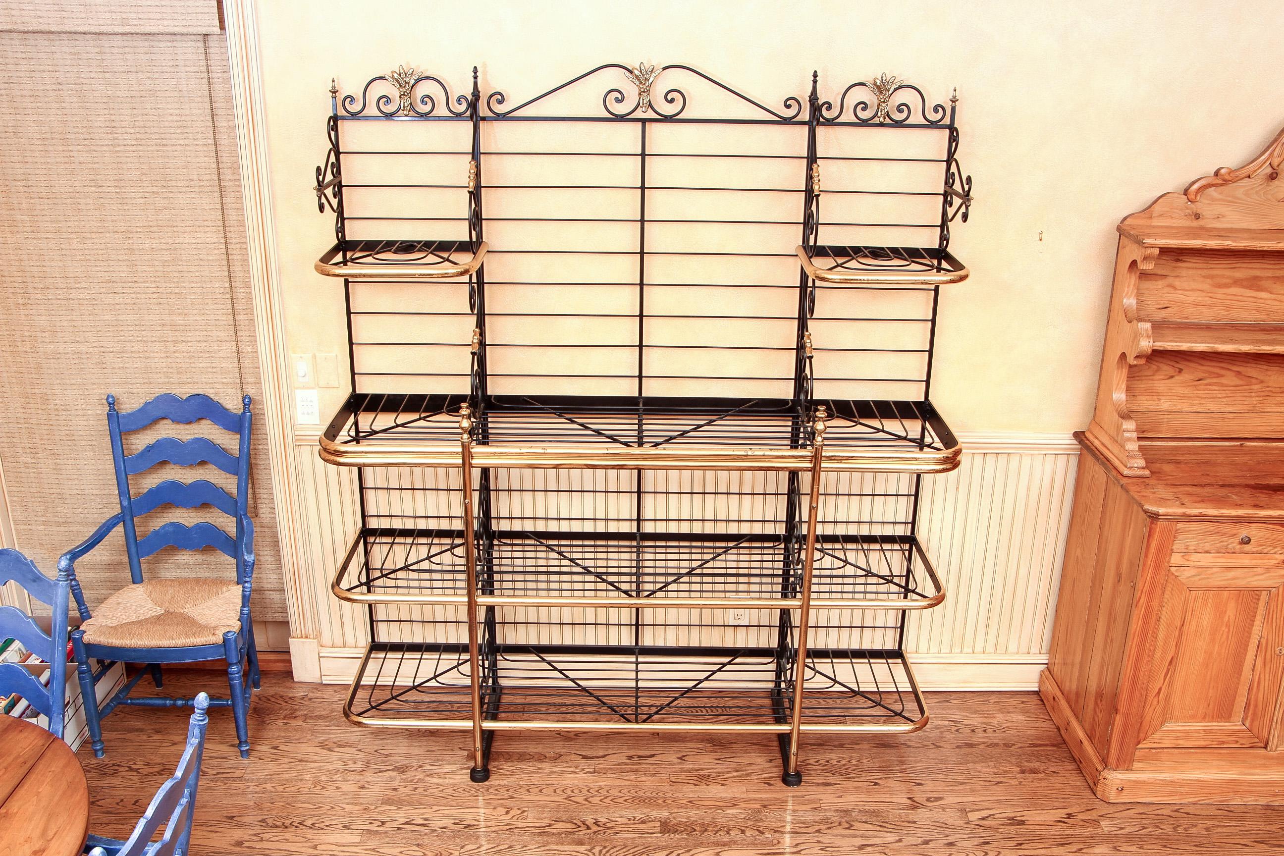 Massive French iron and brass baker's rack, three part iron rack with brass details including a centre motif of sheaves of wheat, scrolled top and sides, and brass banded shelves. By Perfit Fils Ltd., Paris, stamped on the base.

Condition:
