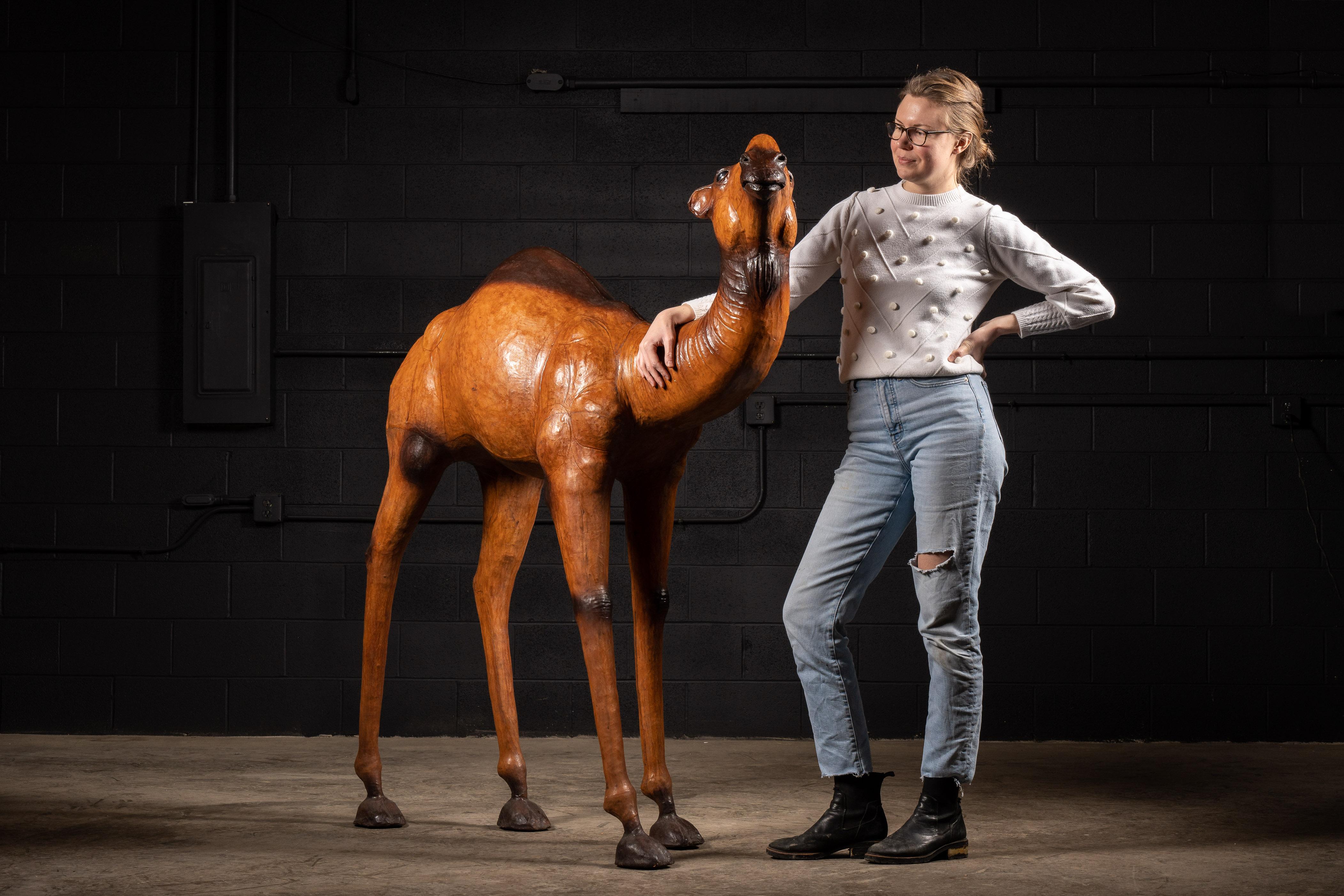 Large, leather-wrapped wooden camel.

This unique decorative piece is one for the books! Using realism, the designer accurately portrays a traditional Dromedary camel, a breed known for their agility that is commonly used in camel racing.
