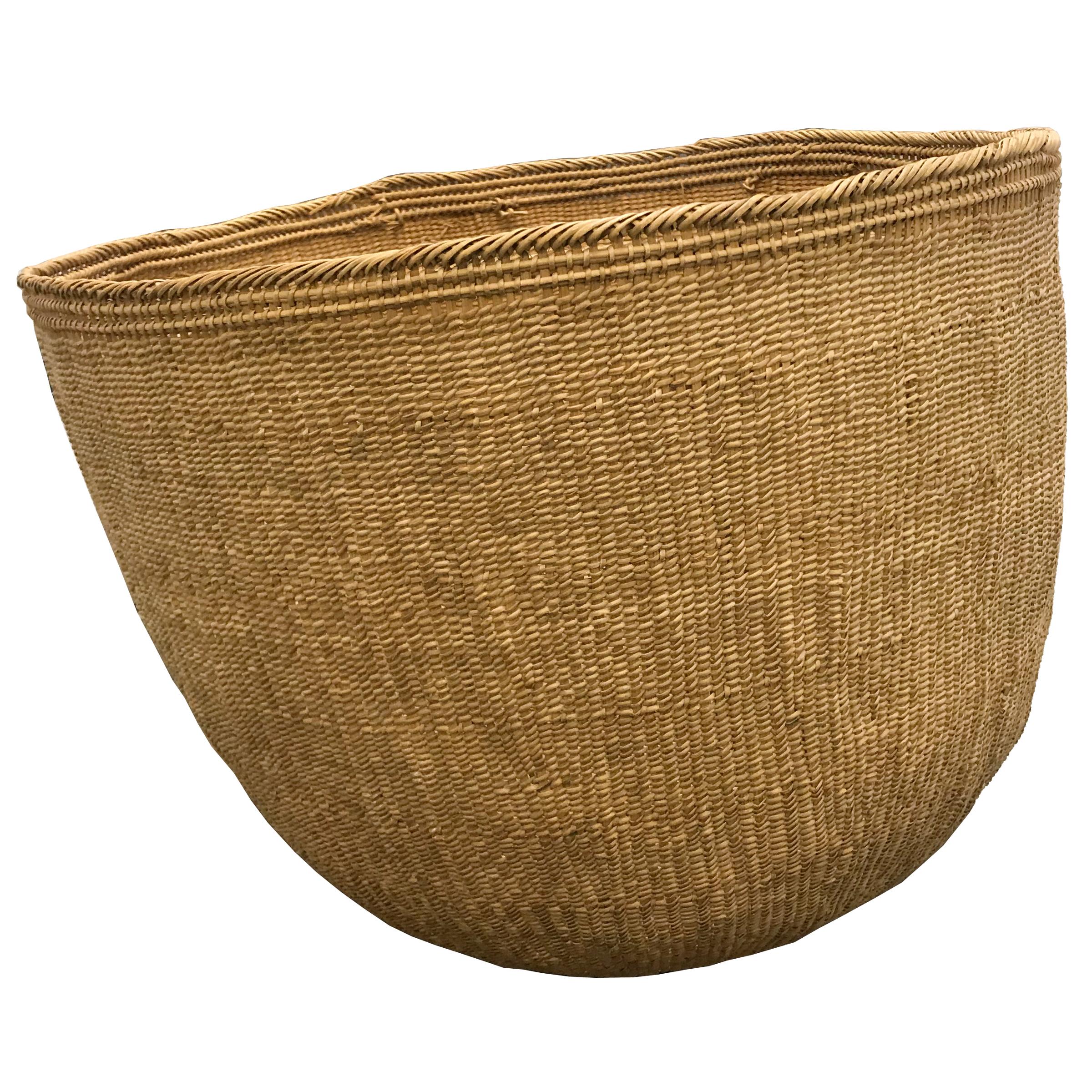 The largest Yanomami basket we've ever seen! The Yanomami are an indigenous people to the Amazonian regions of Brazil and Venezuela. This monumental basket is tightly handwoven of natural fibers with several inner rings for stability, and palm leaf