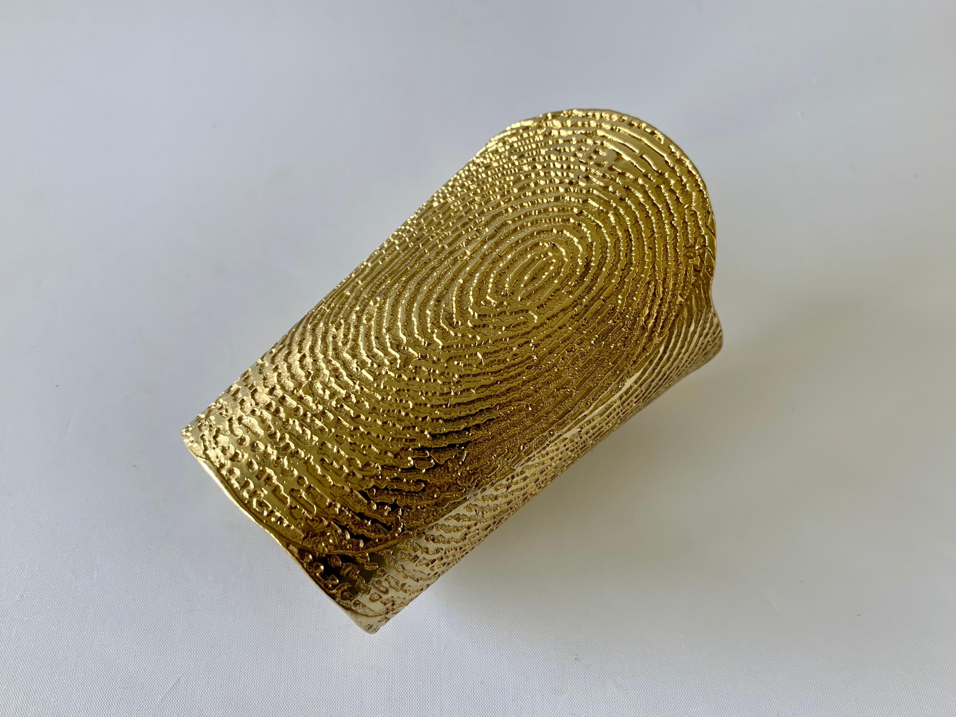 Massive contemporary Yves Saint Laurent runway gilt metal thumbprint pattern cuff bracelet - designed by Stefano Pilati for YSL in summer/springs 2011. The last image is from the runway show and showcases the bracelet as the accessory.