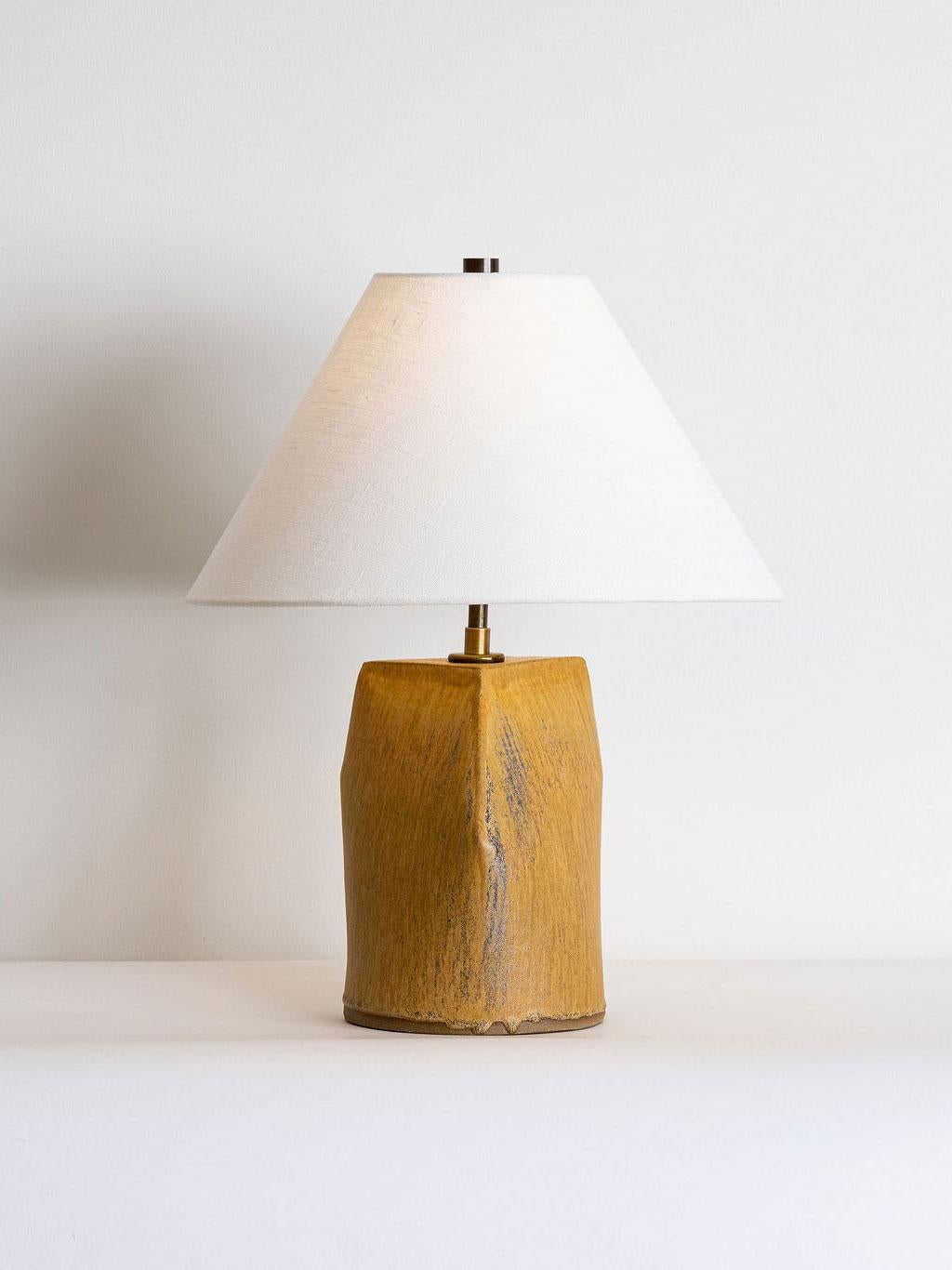 Our stoneware Mast Lamp is handcrafted using slab-construction techniques. 

FINISH

- Dipped glaze, pictured in Hide
- Antique brass fittings
- Twisted beige-cloth cord
- Full-range dimmer socket
- Off-white paper or linen