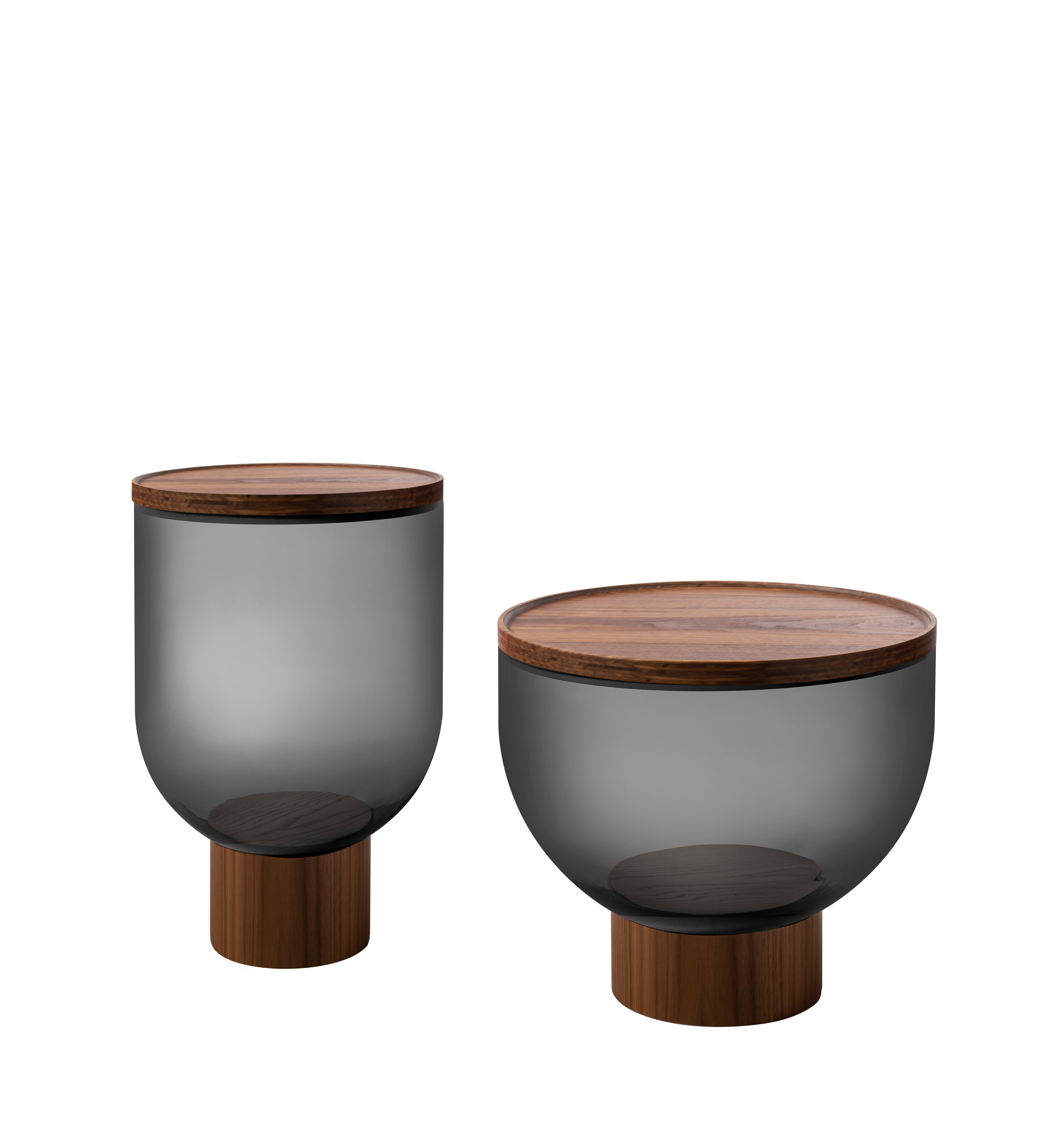 This low coffee and side-table comes with a base and top in Canaletto walnut, natural ash, ash stained black, intense blue or anthracite. The structure's body is made out of blown Murano glass, available in amber, blue-grey or smoke grey. Here you
