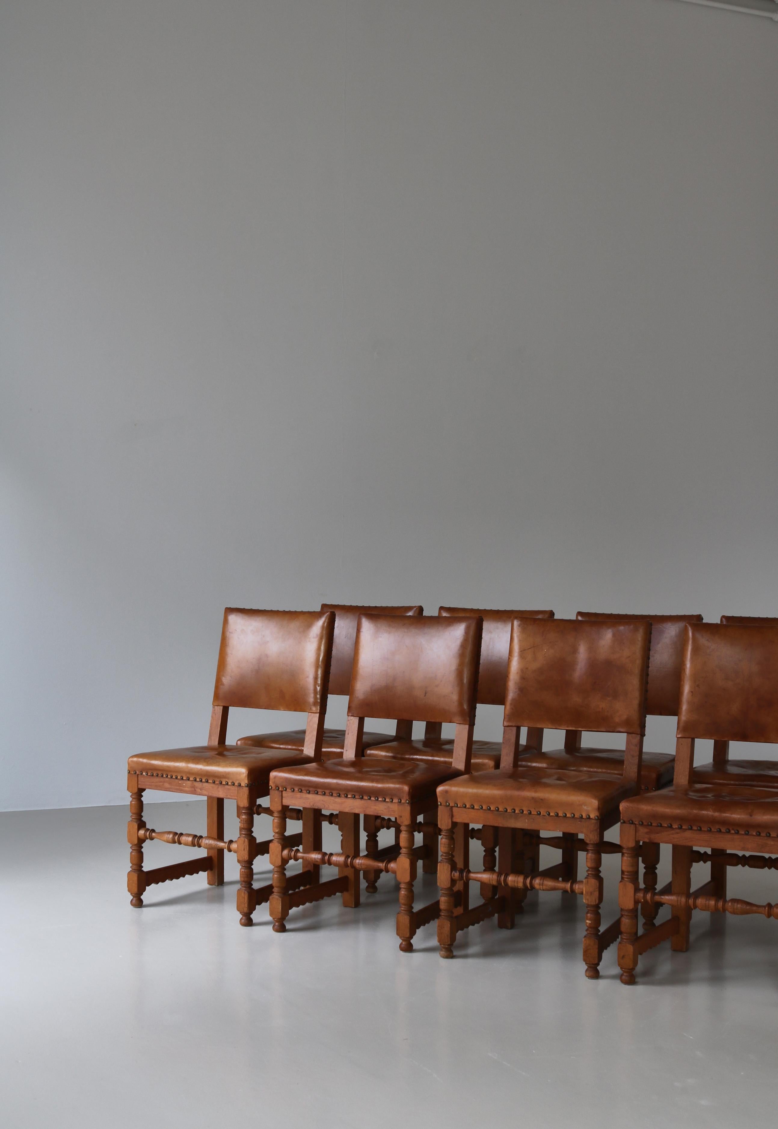 Stunning set of dining chairs in solid oak and natural leather made by Danish Master Cabinetmaker Lars Møller, Copenhagen in the 1930s. The chairs are modern but with a playful expression and many fine details like the turned and carved spokes which