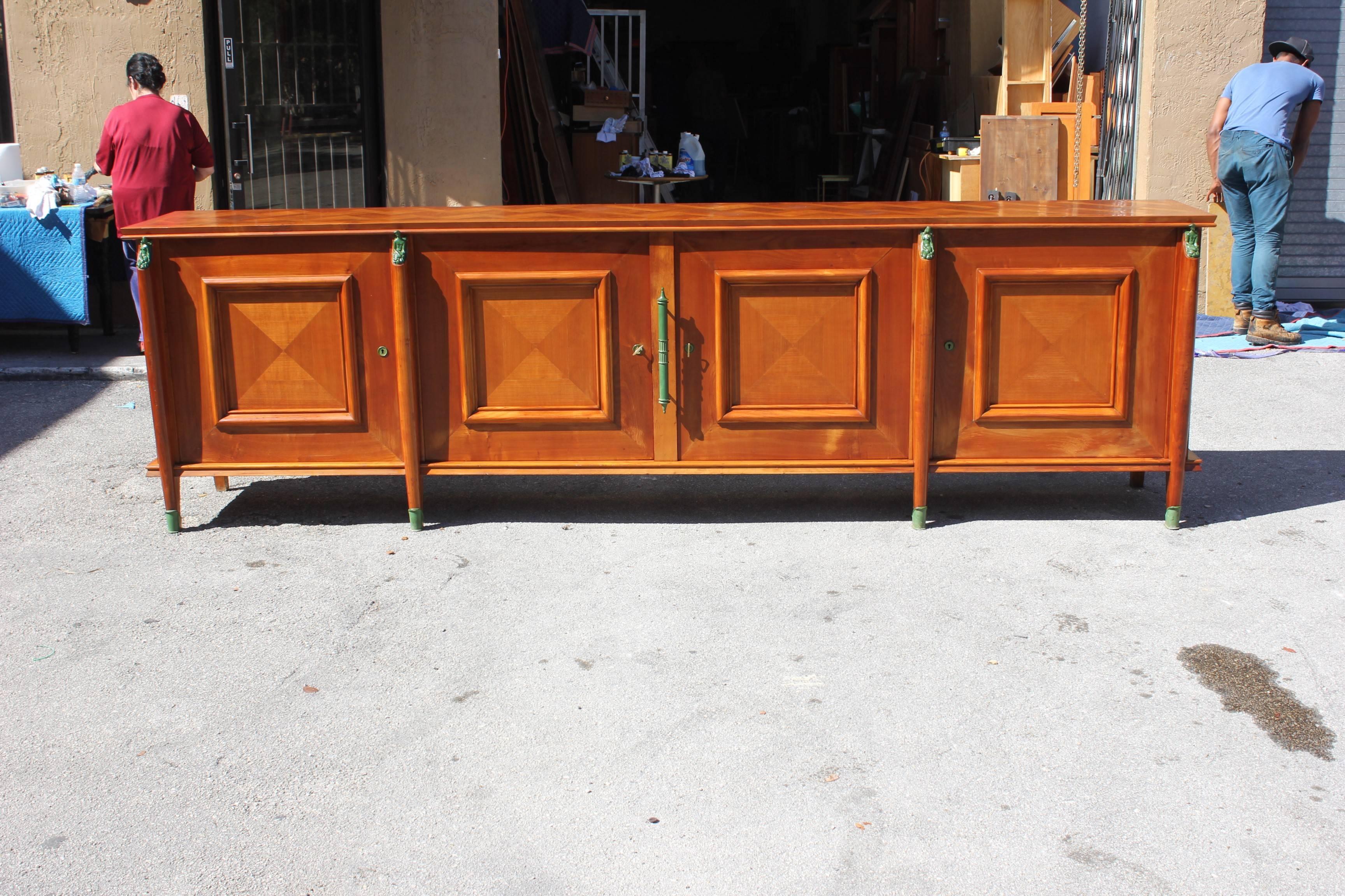 Master piece French Art Deco sideboard or buffet cherrywood by Leon Jallot circa 1930s, beautiful sideboard with four saber legs with green bronze sabot feet, and four green bronze figure man and women and top of the saber legs, very long sideboard