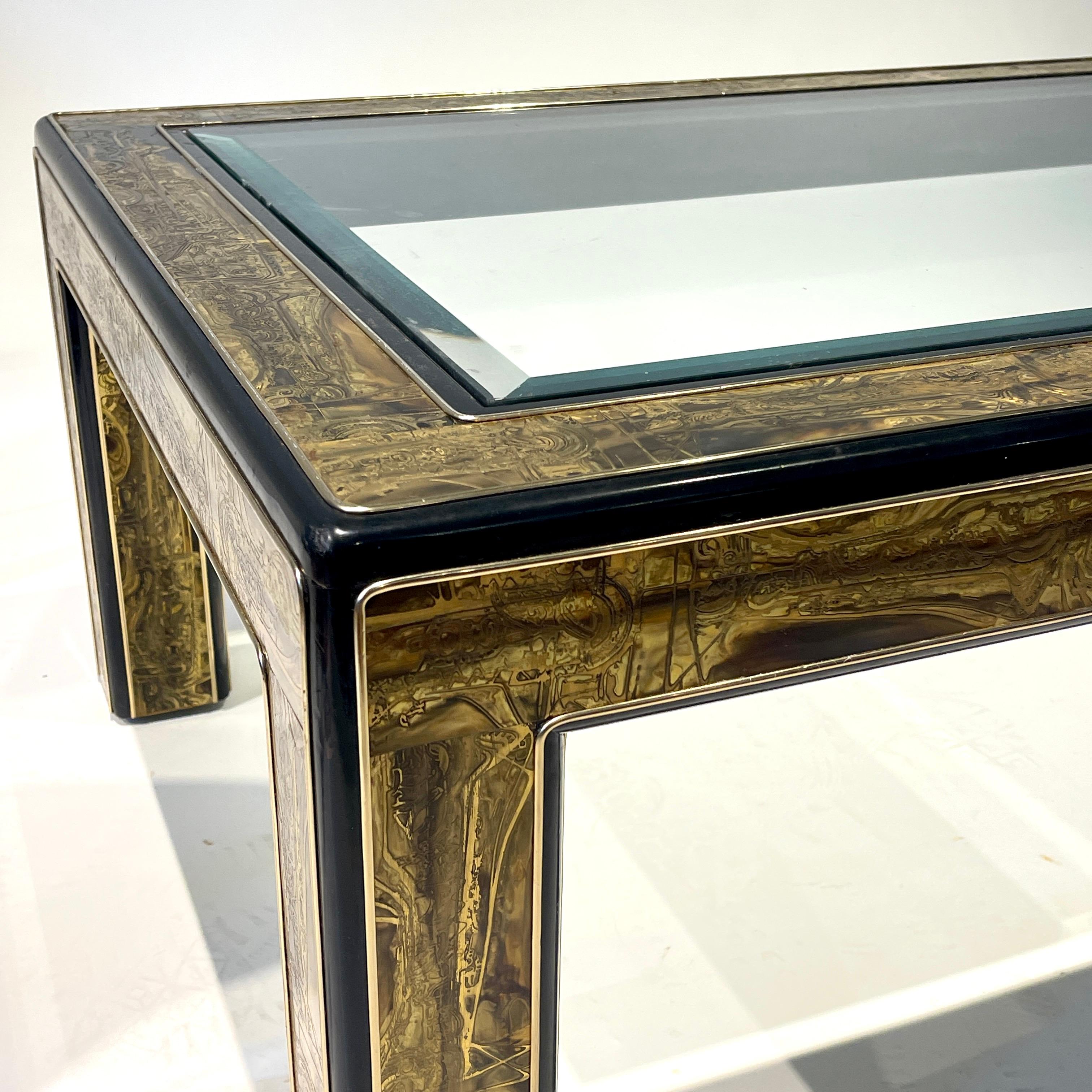 Stunning table by Mastercraft. Constructed of Bernhard Rohne acid etched brass panels with a sleek rounded black lacquered edge.