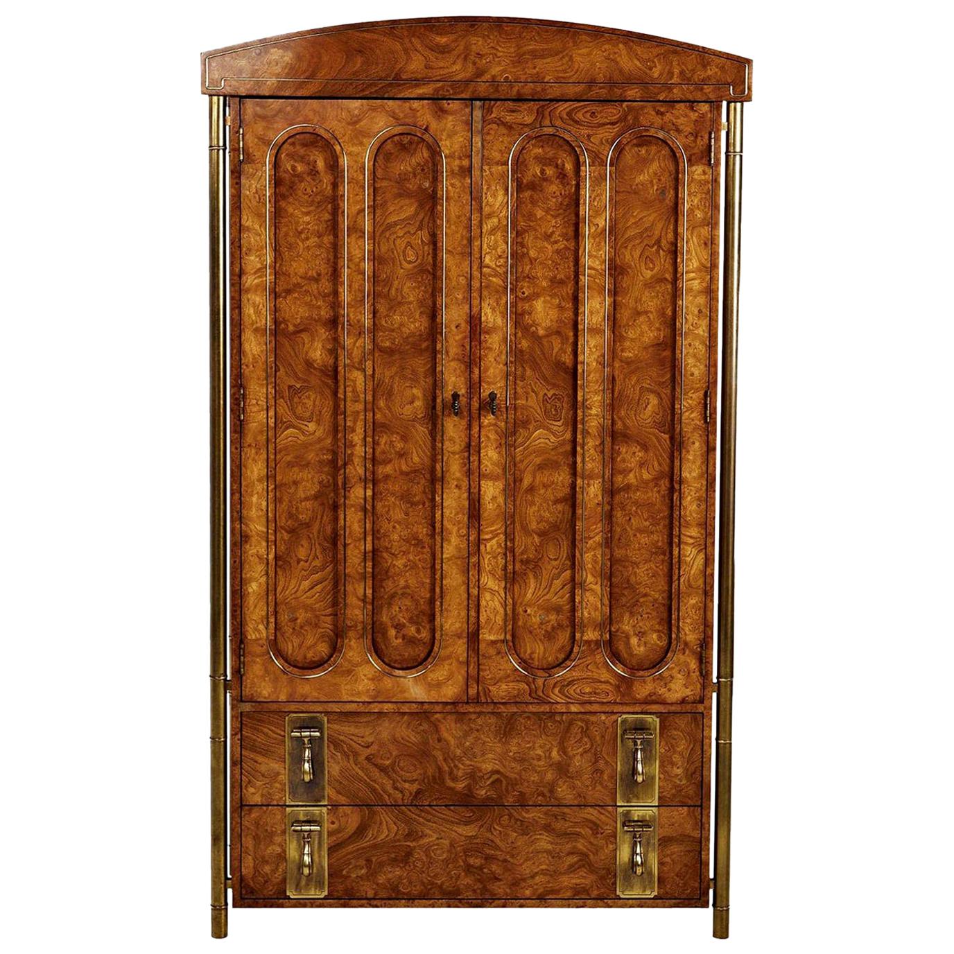 Breathtaking burl wood and brass Mastercraft armoire. Four tubular outer skeletal brass support legs create a floating effect. The columns are fashioned in the style of bamboo stalks to add an Eastern flare. Hollywood Regency and Asian Modern meld