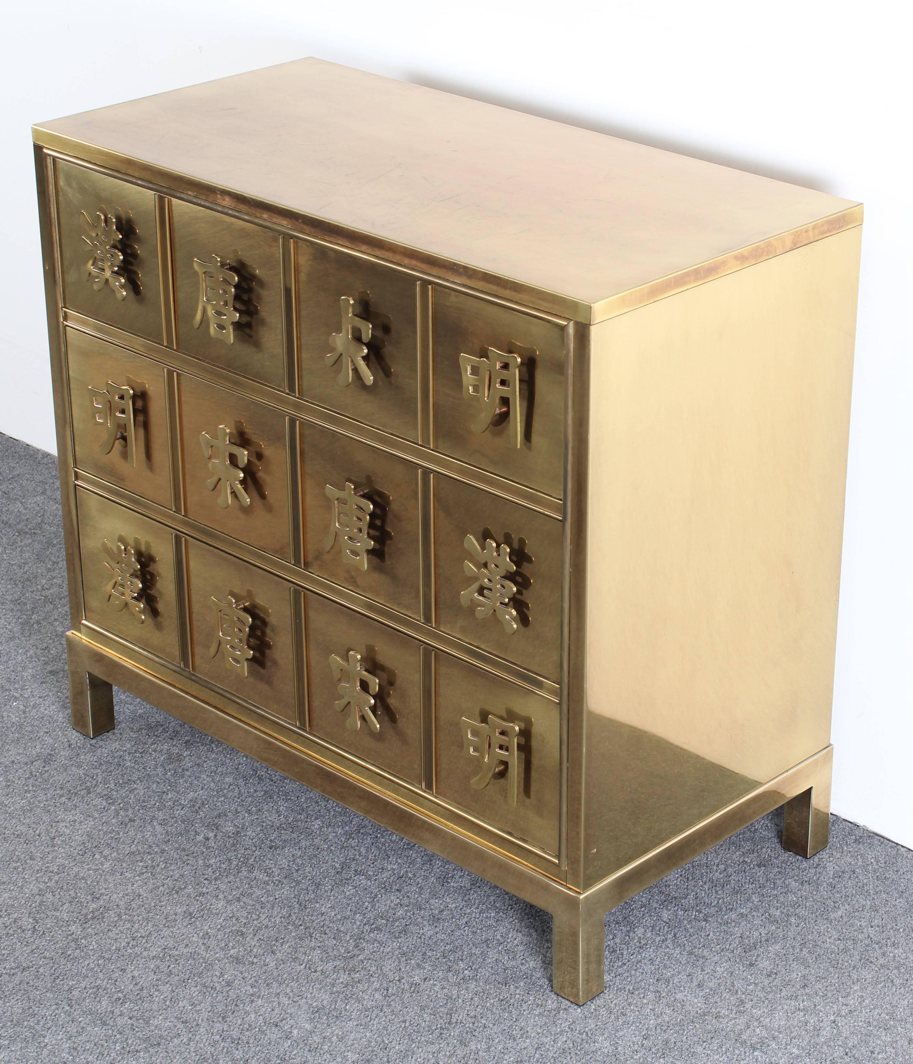 A stunning Mastercraft Asian style chest with Chinese or Japanese character brass pulls, 1970s. Well constructed with age appropriate wear. The cabinet has some minor spotting but overall is in very good condition. One handle has a very minor chip