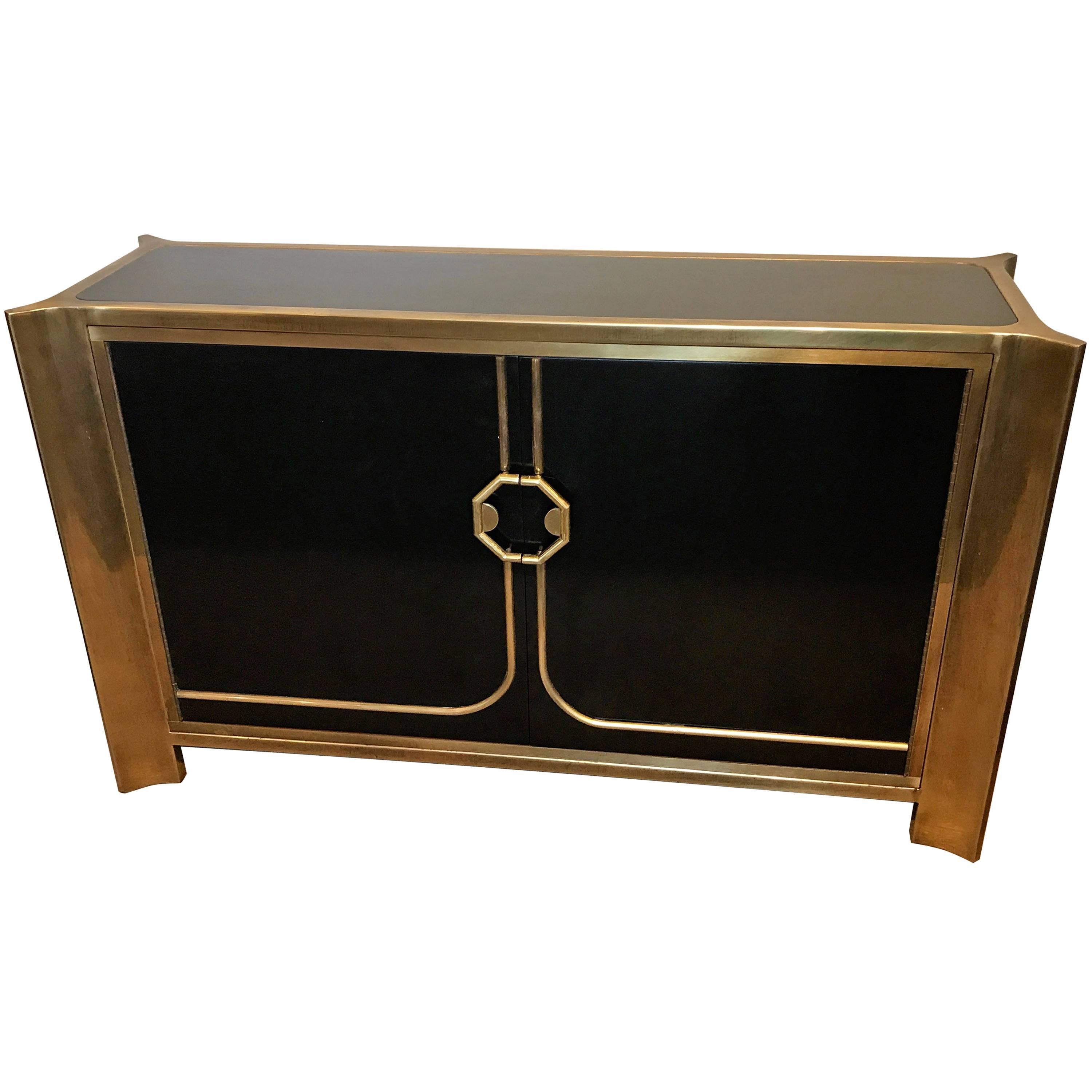 Mastercraft black lacquer and brass credenza, fitted with one interior shelf.