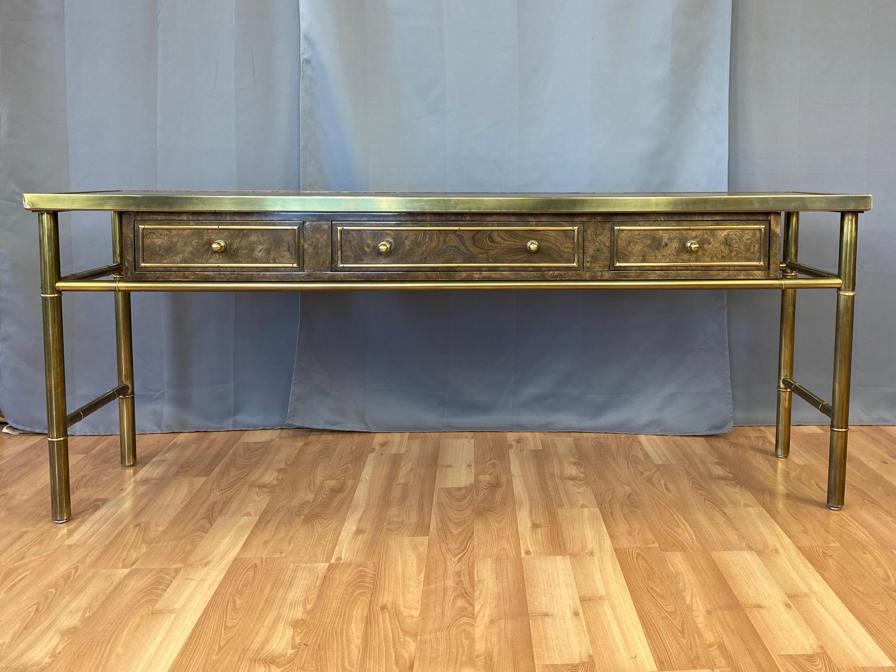 An exceptionally chic and uncommon 1970s Mastercraft brass and burl wood console or sofa table with drawers and acid-etched top.

Clean Italianate design with frame, trim, pulls, and stylized Chinoiserie legs in Mastercraft’s signature antiqued