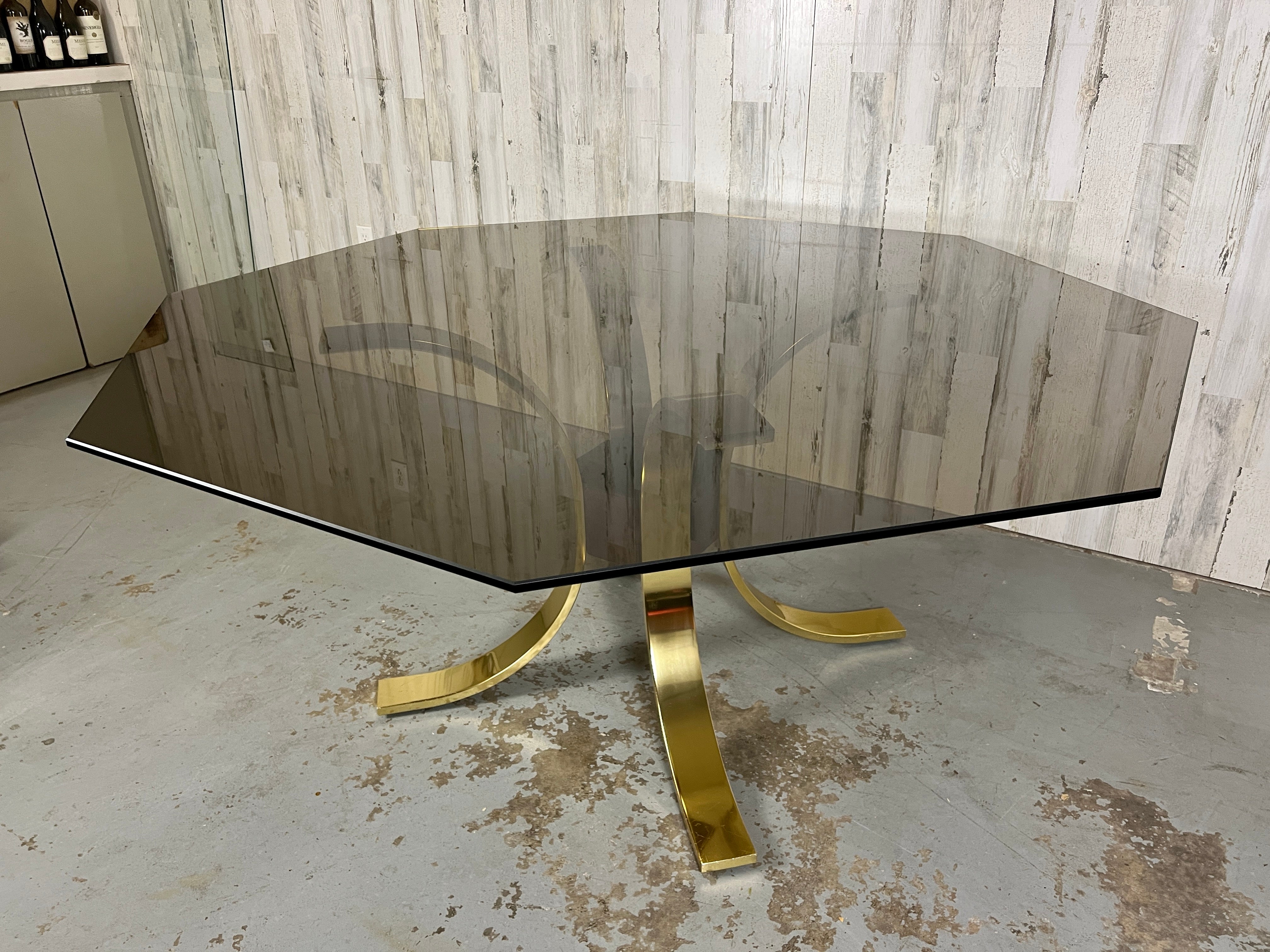 Brass, burl, & smoked octagonal shaped glass dining table by Mastercraft, Lotus design with four curved brass legs and a burl wood center hub with a octagonal smoked glass that rest on top. Very elegant combination.
Base only: 32 L x 32 W x 28.75 H.