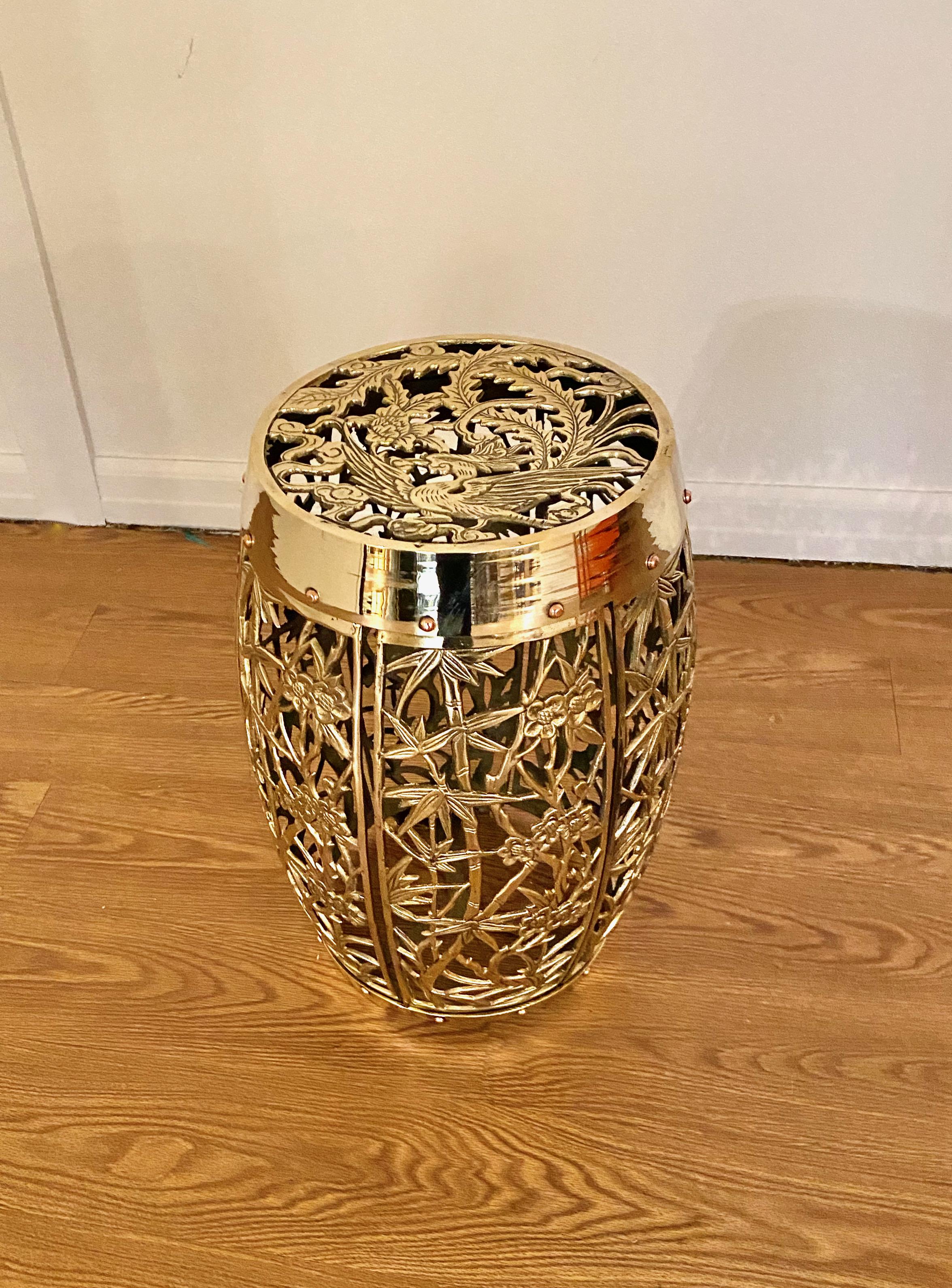 This is a classic Mastercraft brass Chinoiserie-style garden stool in the Phoenix & Bamboo pattern. The stool is in excellent condition having been newly polished.