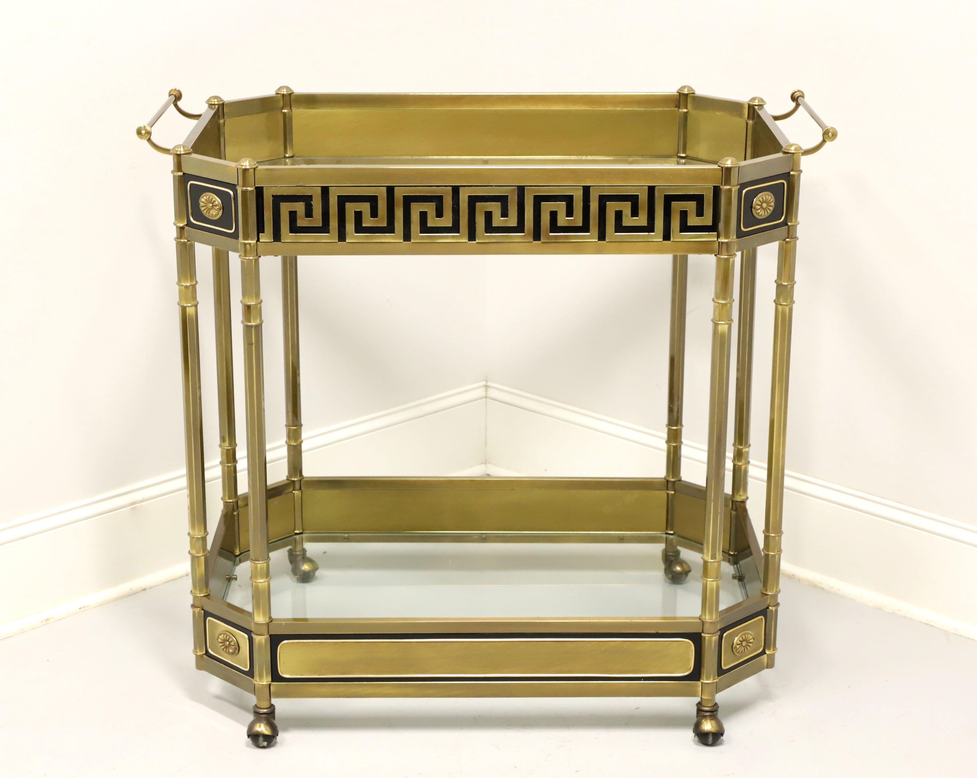 A Neoclassical style rolling bar cart by Mastercraft. Solid brass with glass top, rectangular shape, clipped corners, glass lower shelf, Dual brass handles, and four casters. Features Greek Key & Neoclassical details and a short upper & lower