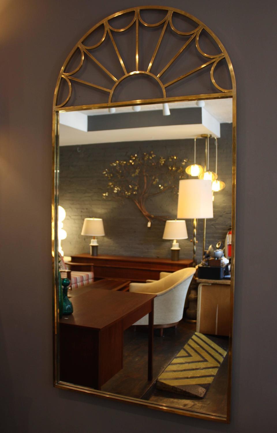 This large tubular brass wall mirror was manufactured by Mastercraft in the 1970s. Though its design inspiration draws from 17th century Palladian architecture, the clean lines, materials and technique modernize the Classic design.