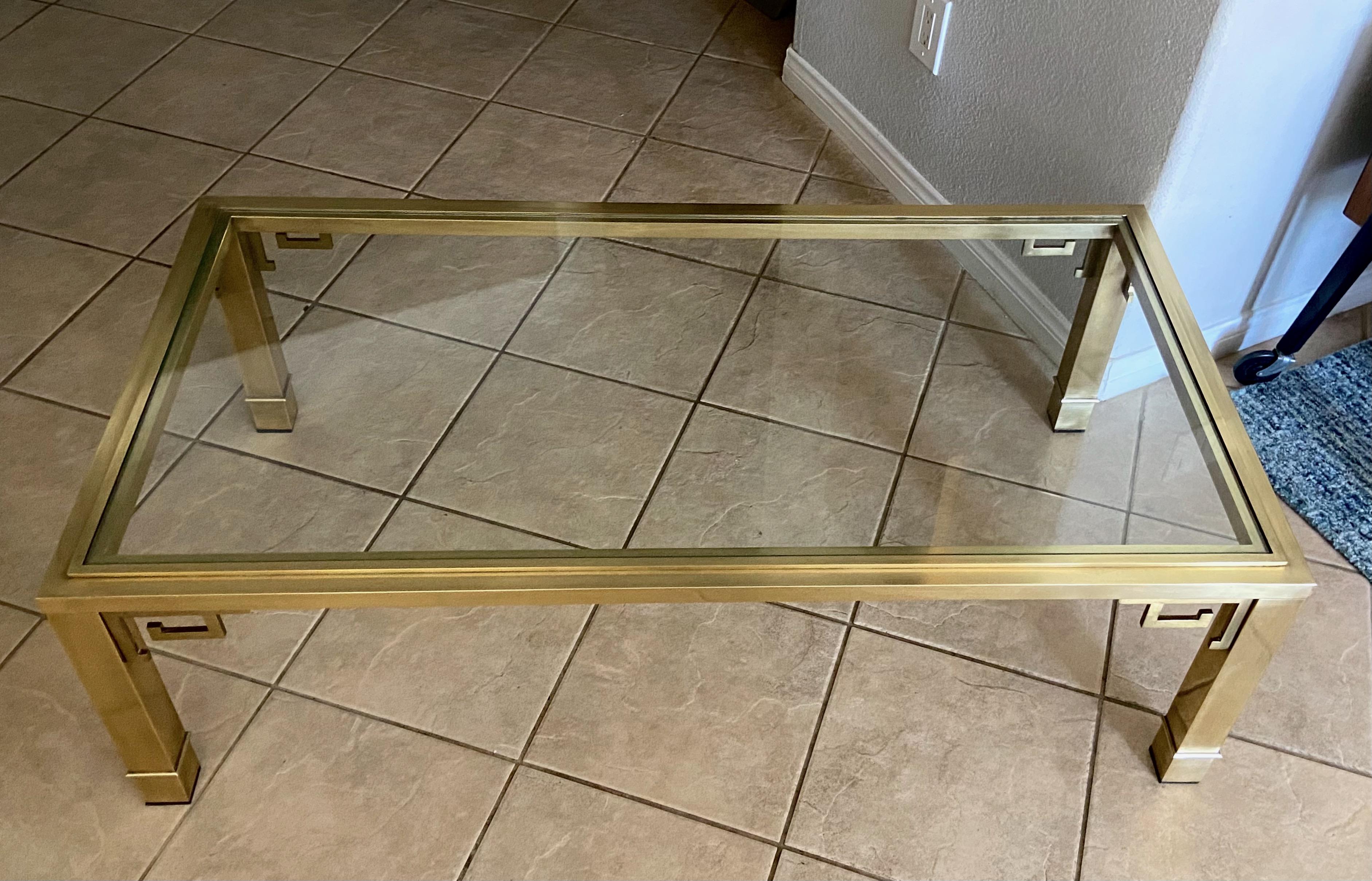 Mastercraft rectangle brass and glass top cocktail coffee table with Greek key motif detailing.