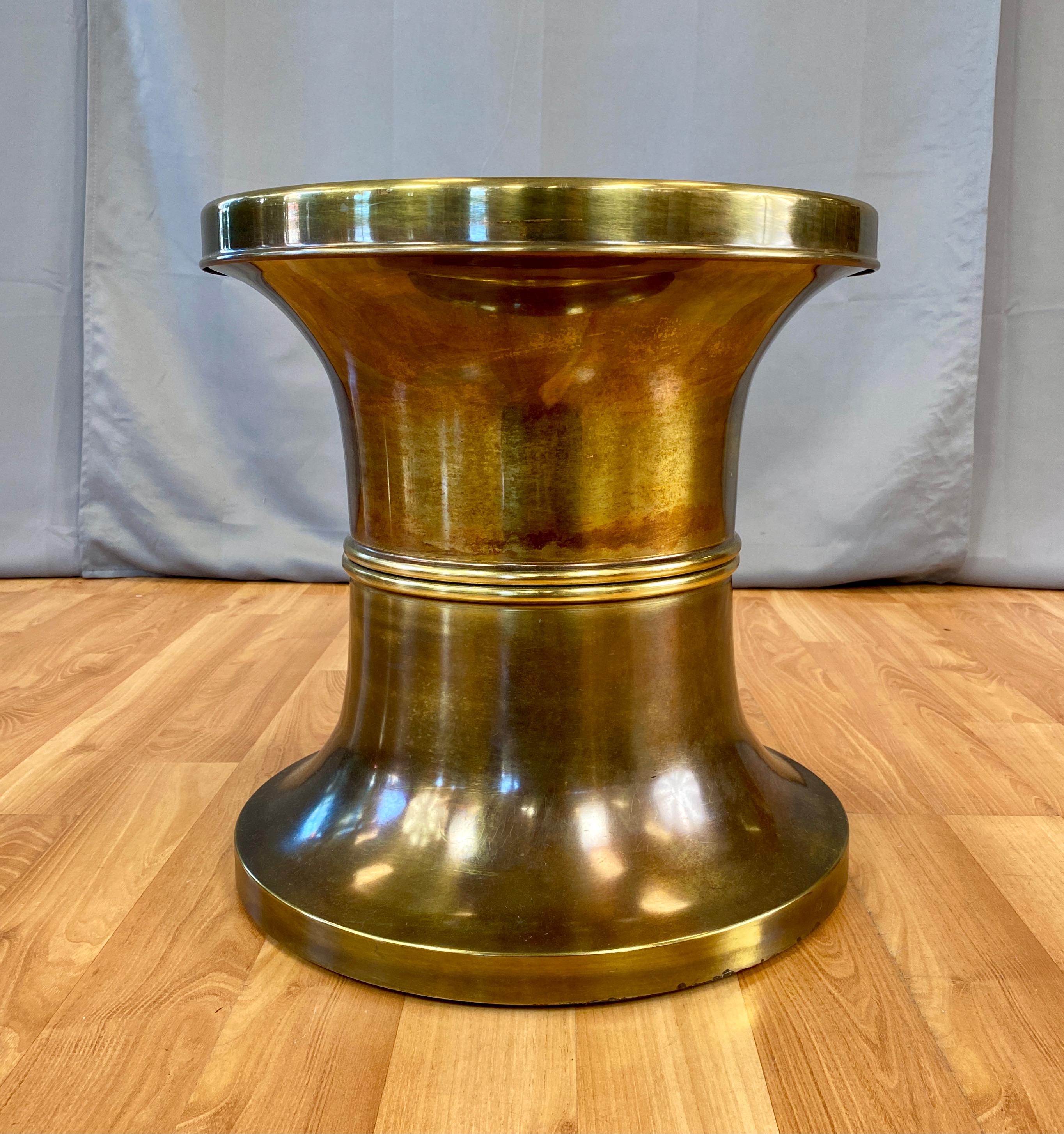 A very handsome vintage Mastercraft stool, that could also work as a low side table .
Nice graceful hourglass shape, with a light patina, circa 1970s.