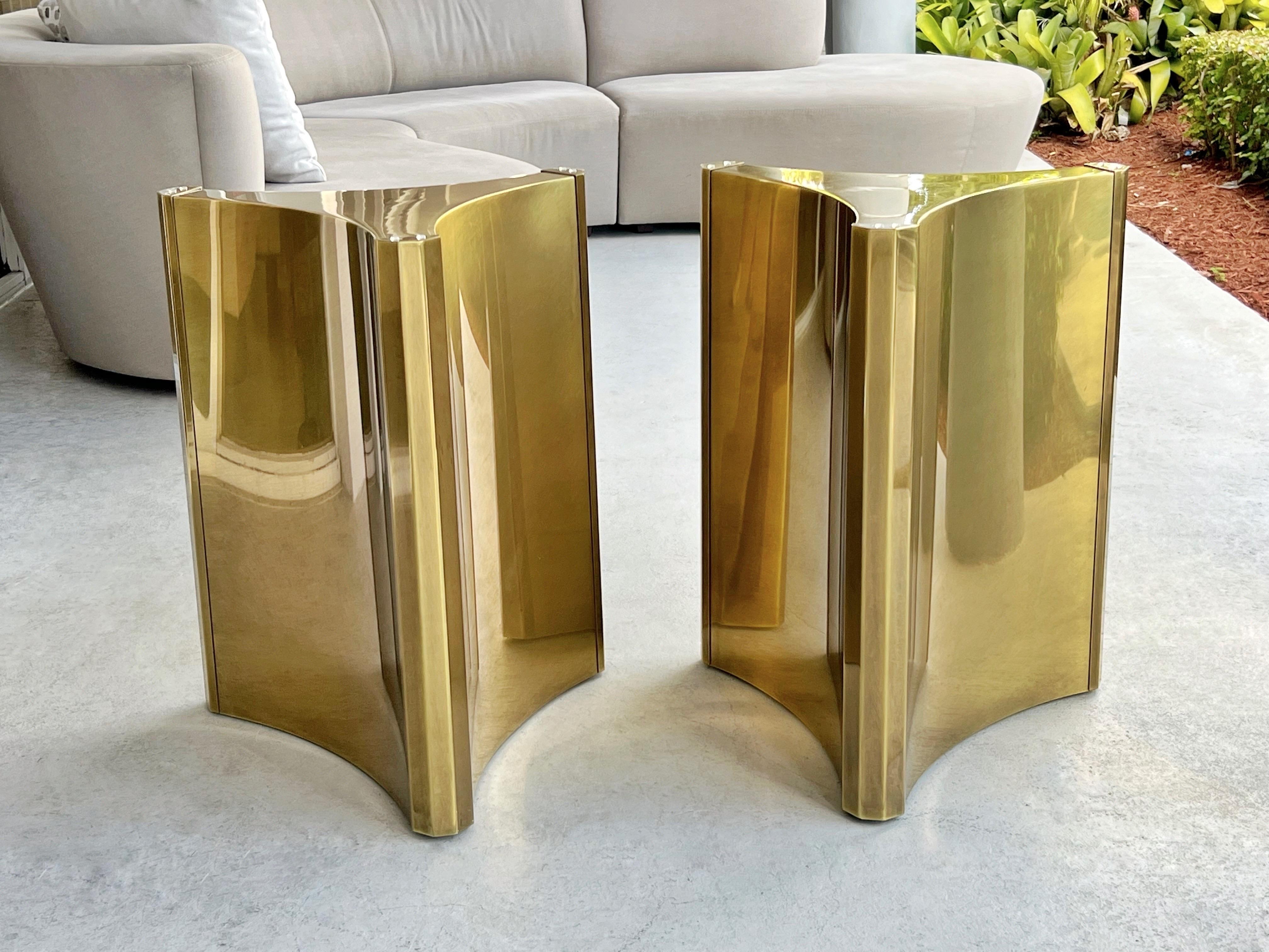 A fantastic Mastercraft dining table. 2 triedri brass bases support the glass top. 
The bases retain the original patina.