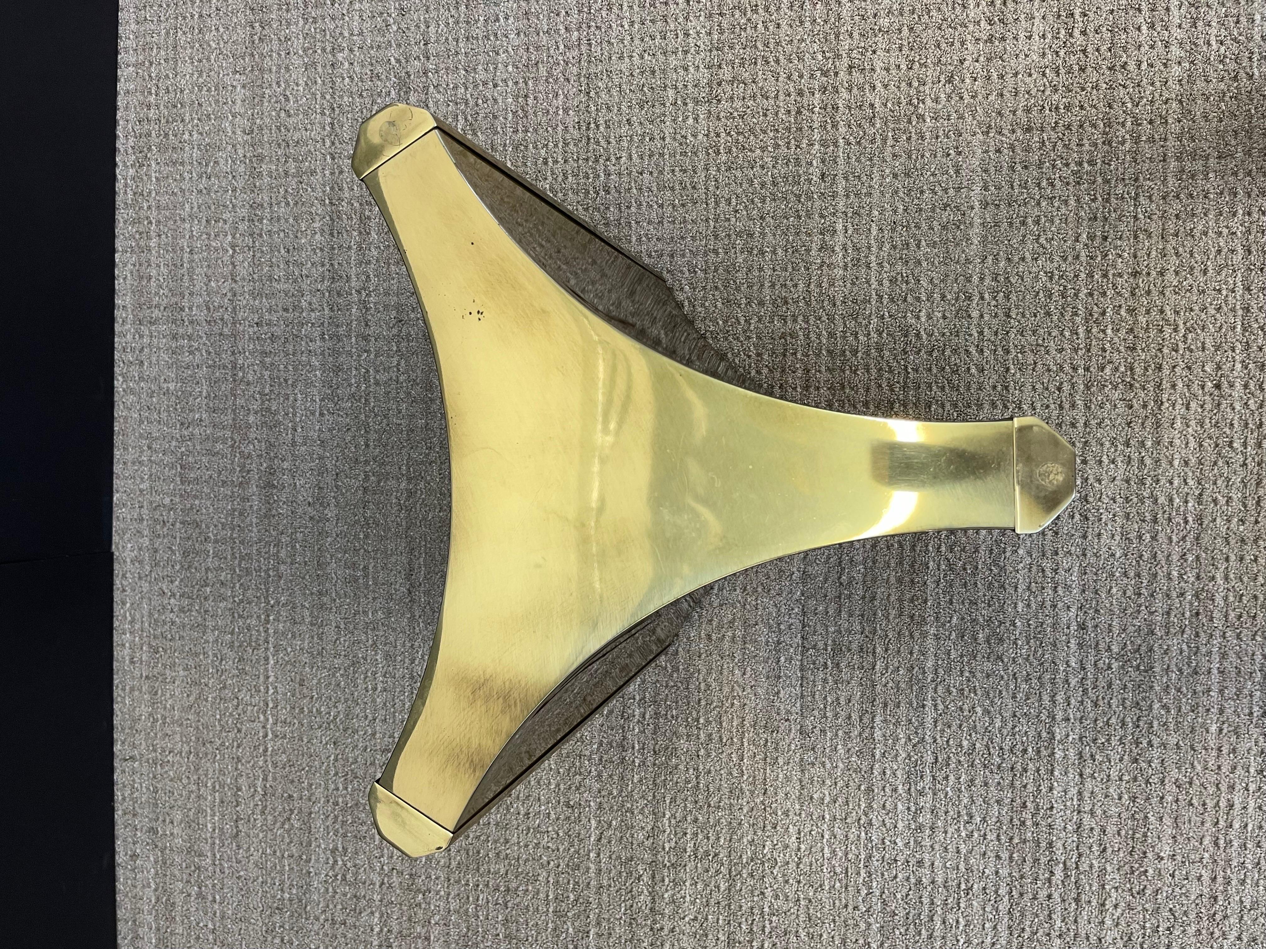 One of the hottest items currently with interior designers are these gleaming brass 'Trilobi' Mastercraft dining table bases, which also work excellent for a desk, feature a hefty triangular design with sculpted ends. The gorgeous brass displays