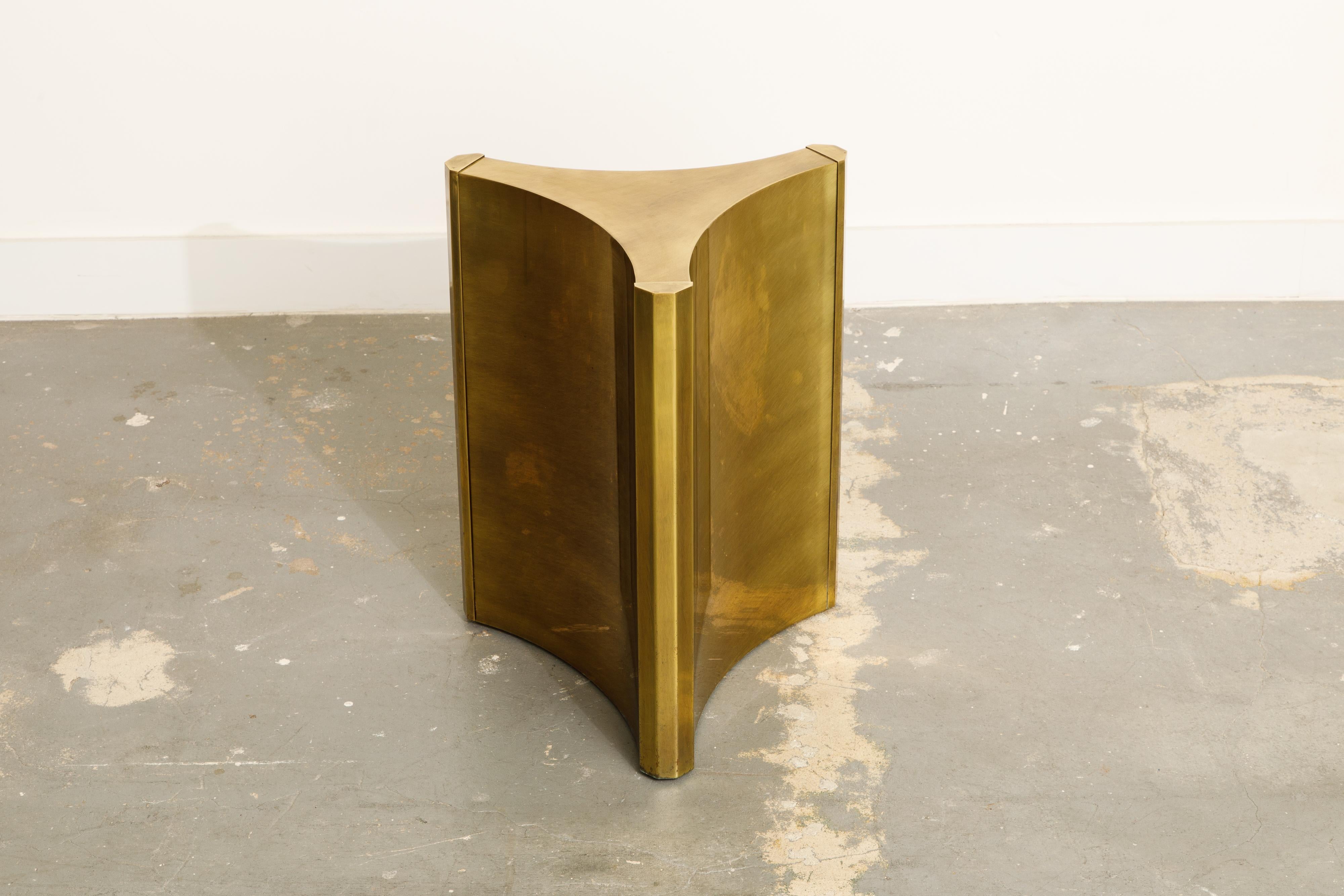 These gleaming brass 'Trilobi' Mastercraft dining table bases, which also work excellent for a desk, feature a hefty triangular design with sculpted ends. The gorgeous brass displays subtle signs of an admirable patina, which can be highly