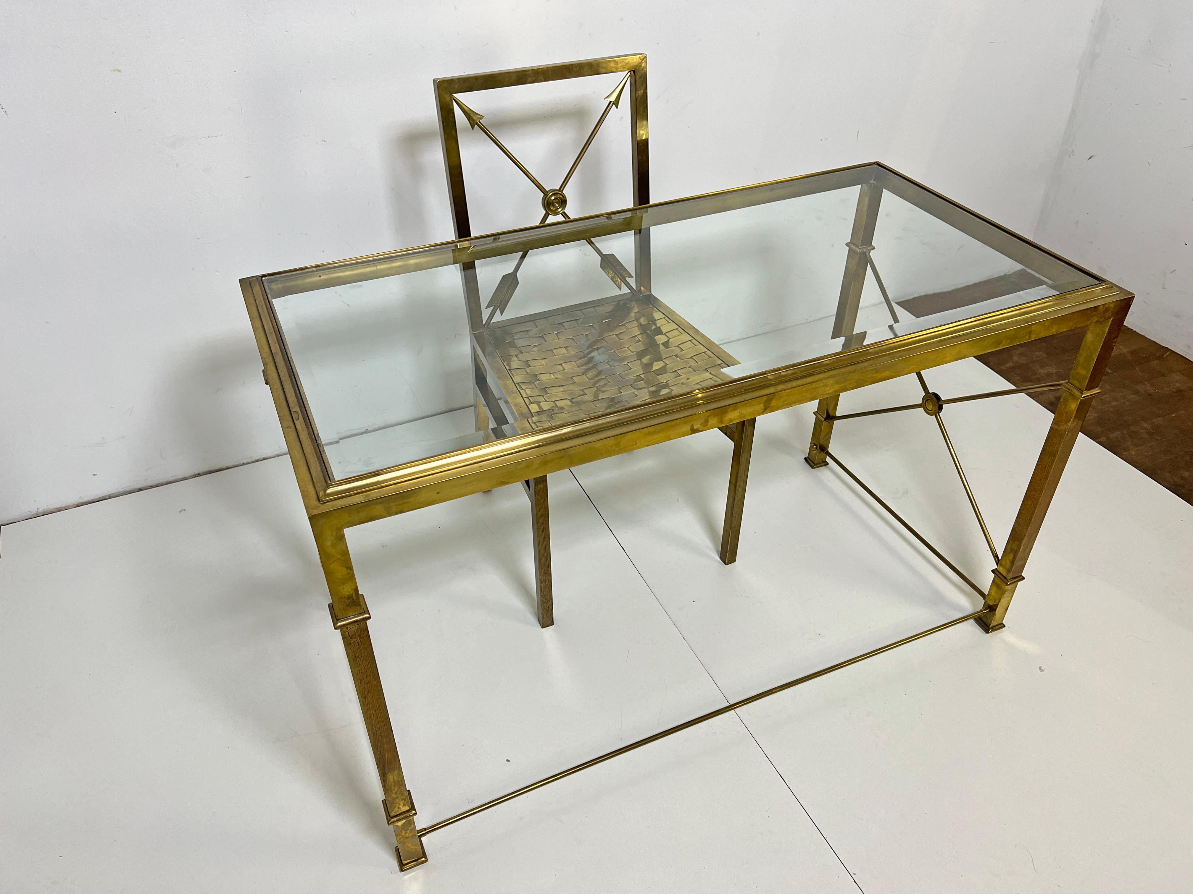 n extremely rare solid brass writing desk and chair with a stylized neoclassical motif of crossed arrows and target medallions. The chair is fitted with an unusual basketweave seat of brass splints. These were crafted in Italy during the 1960s for