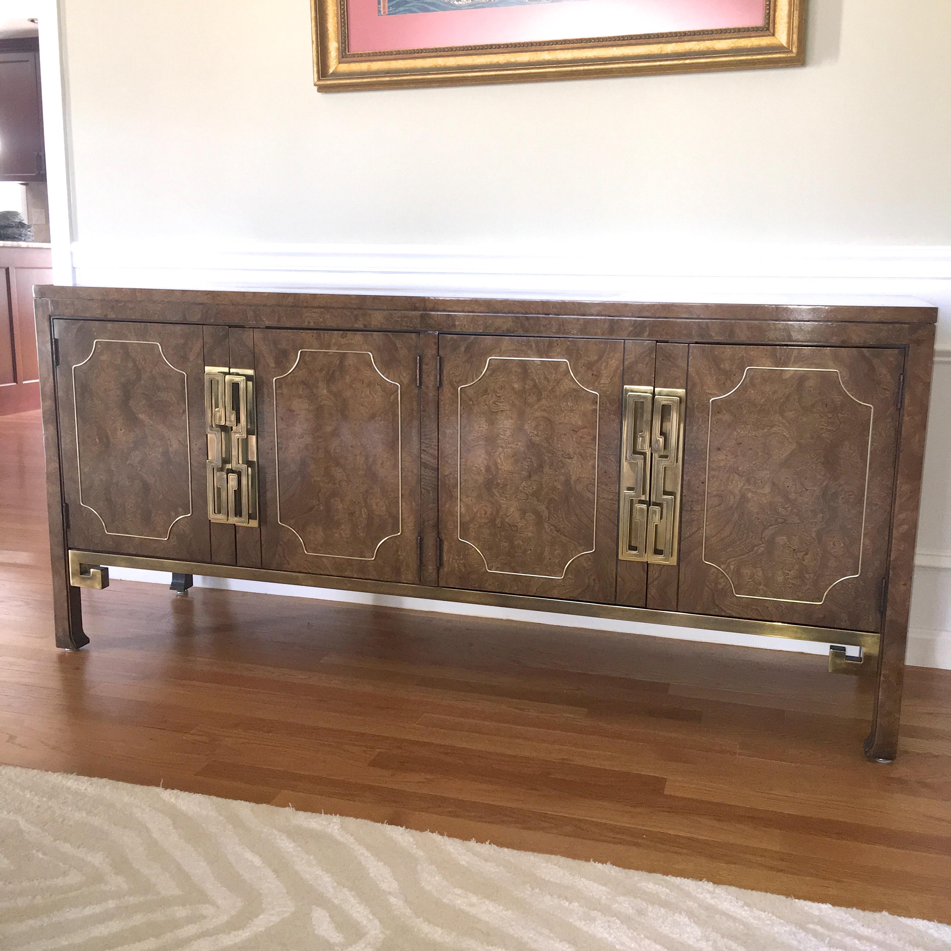 Vintage 1960s sideboard buffet designed by William Doezema for Mastercraft retailed by Charak of Boston. Briar root burl veneer although frequently identified as Amboyna. Hefty brass embellishments and hardware. Divided case with two open storage