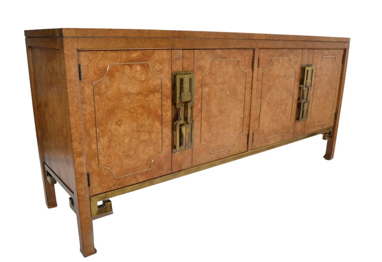 Incredible William Doezema designed Burl Wood, brass and metal credenza, Sideboard or Cabinet.
Features 4 doors and 2 drawers, decorated with Brass Pulls, Borders and Metal Greek Key Base.
The light Brown Burl Wood has a beautiful grain