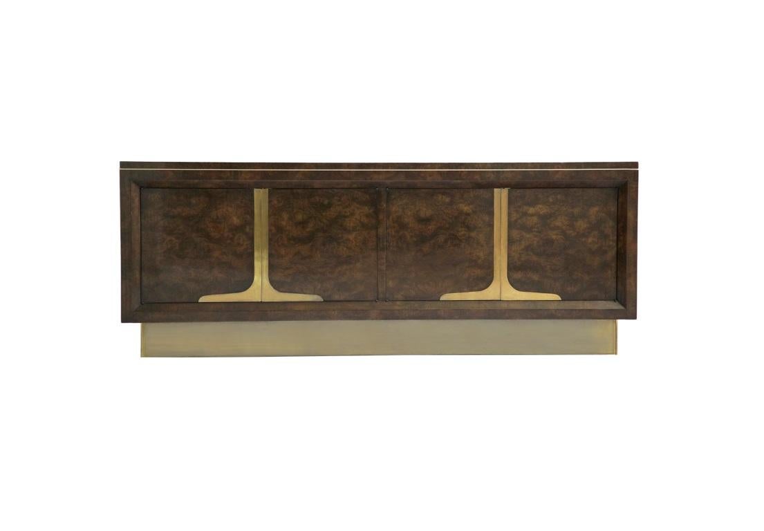 This breathtaking sideboard/credenza from Mastercraft, circa 1960s. The piece exhibits the expected level of craftsmanship and design quality produced by this noted furniture maker. Features a beautiful burled amboyna wood finish with brass accents