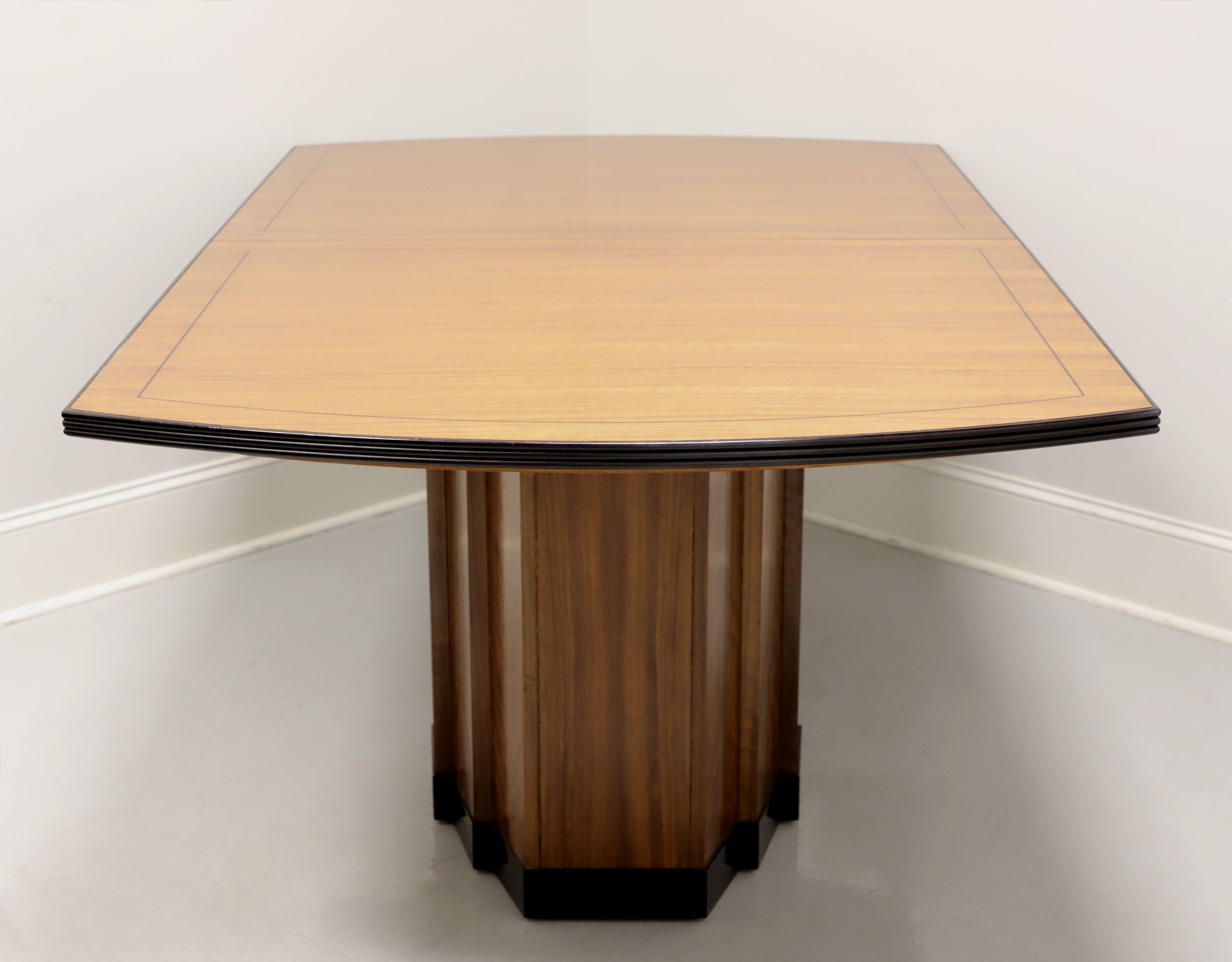 A Contemporary style rectangular dining table by Mastercraft, a division of Baker Furniture. Solid banded hardwood top with a wavy grain, rounded ends, black painted ribbed apron, an architectural flare to the veneered solid pedestal bases with
