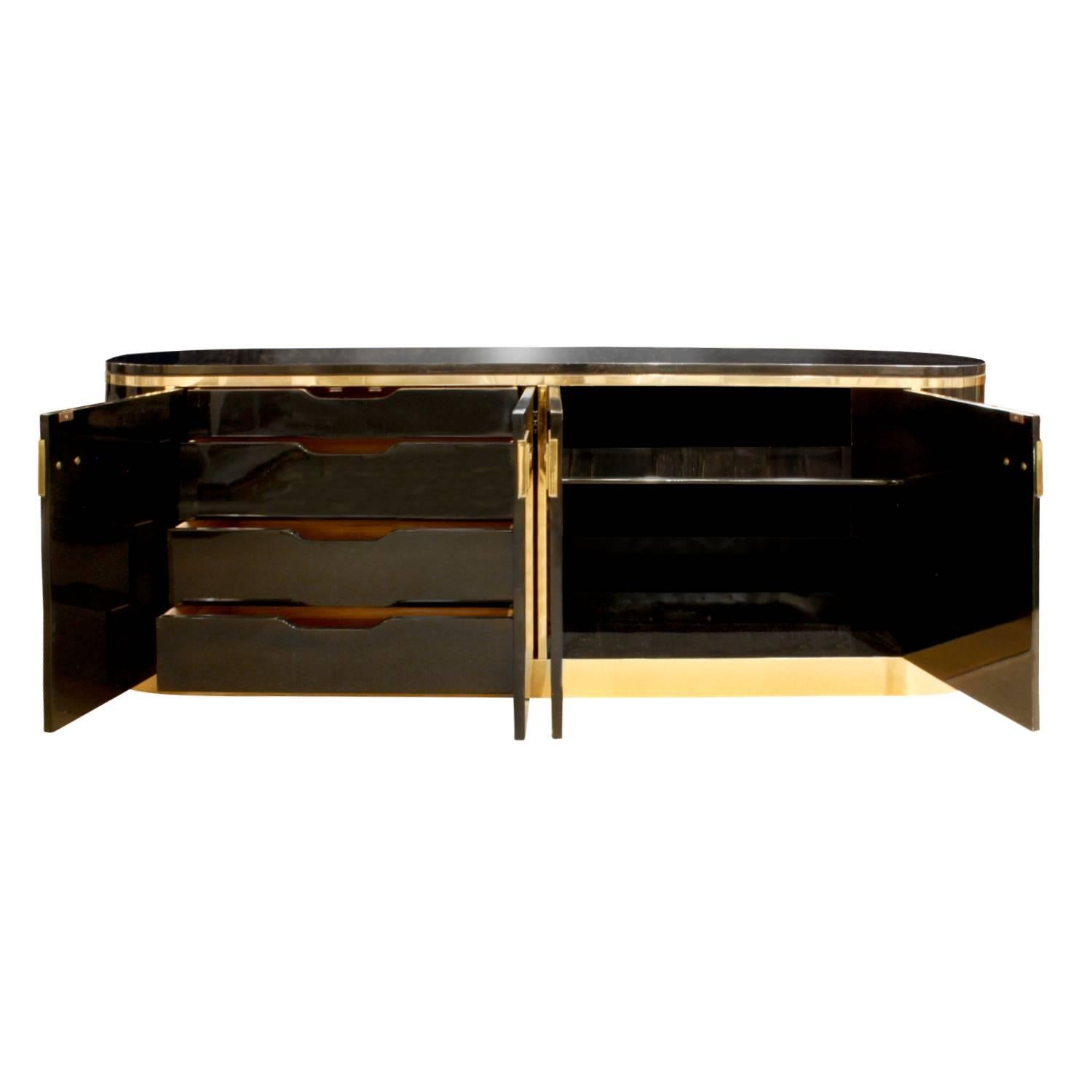 Credenza with rounded ends in black lacquer with brass hardware and accents by Mastercraft, American, 1970s. This is a very chic design.
